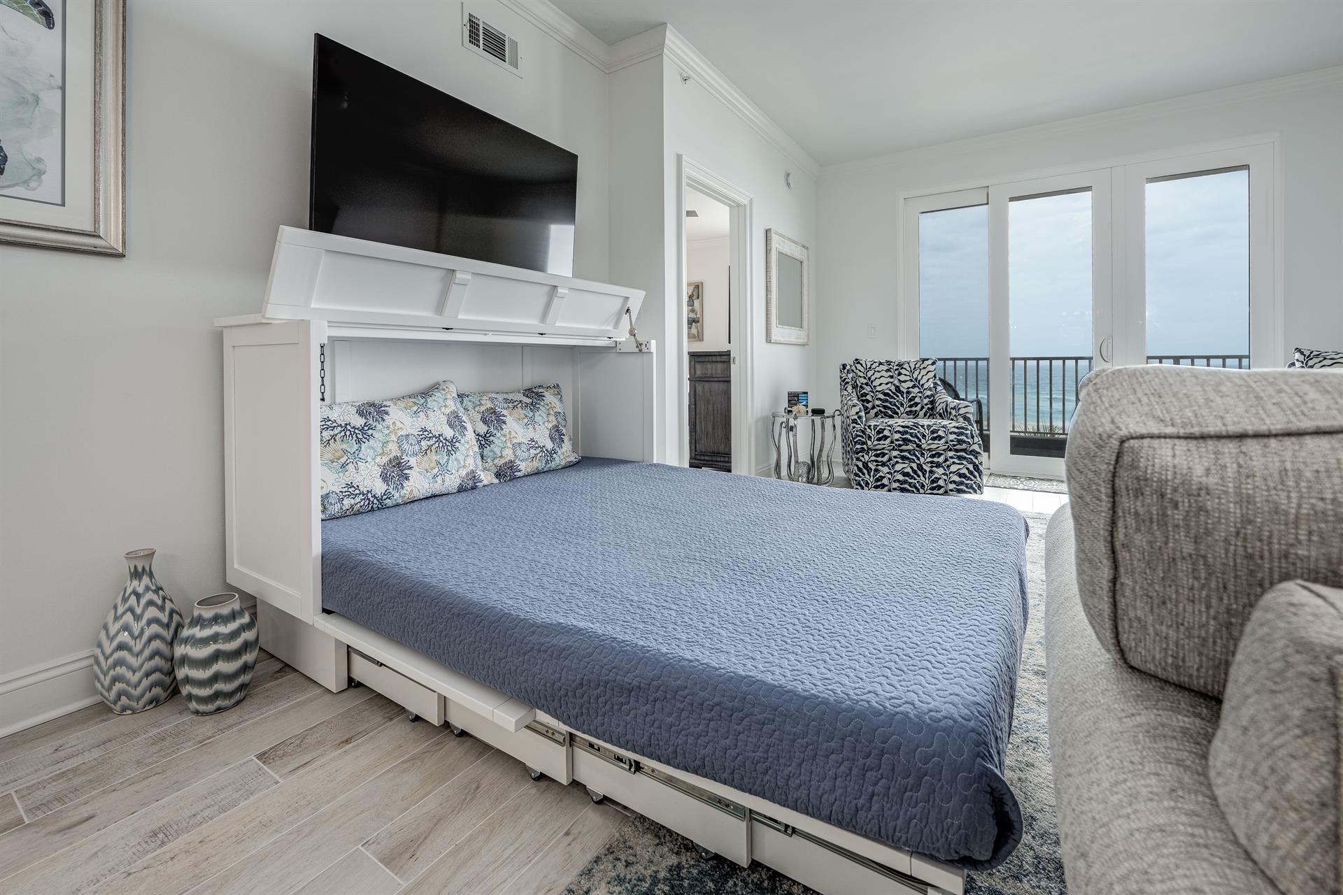 Murphy queen bed pulls out from sleeper cabinet in living room