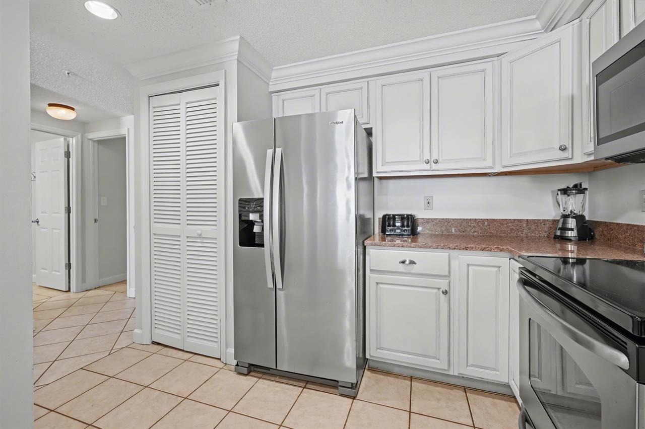 Kitchen with WasherDryer in closet next to fridge