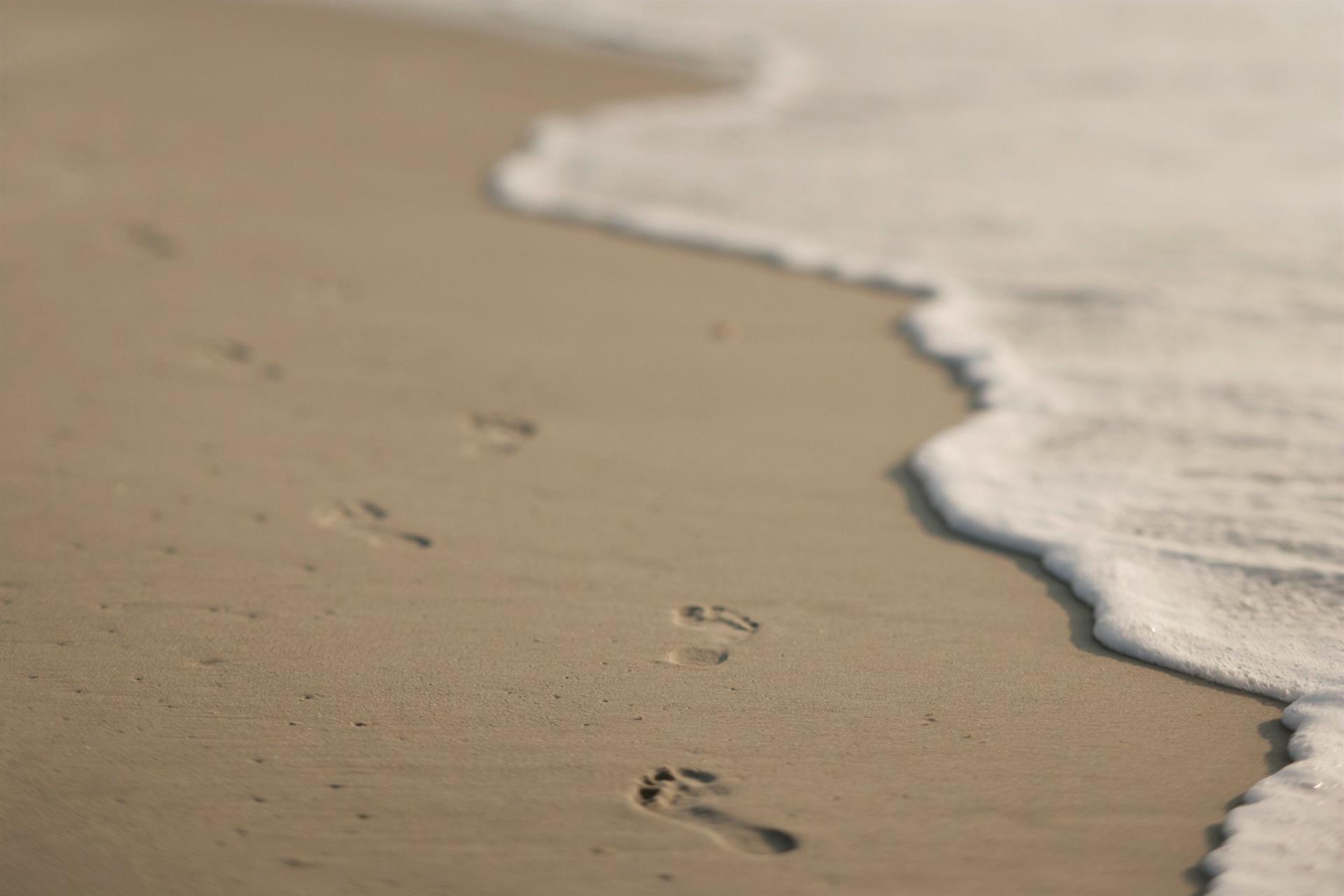 footprints on sand at the beach