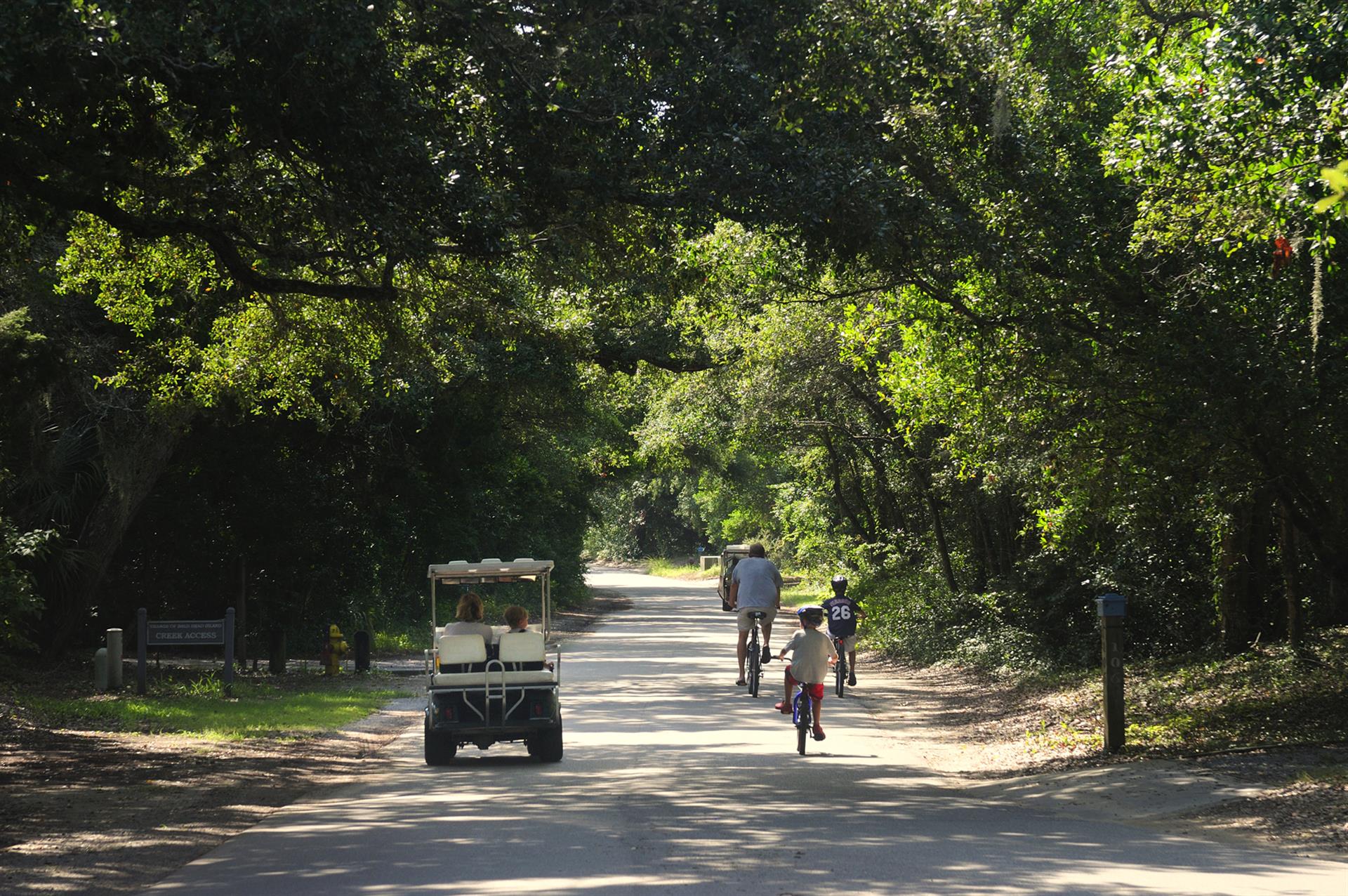 electric carts and bikers along Federal Road on Bald Head Island