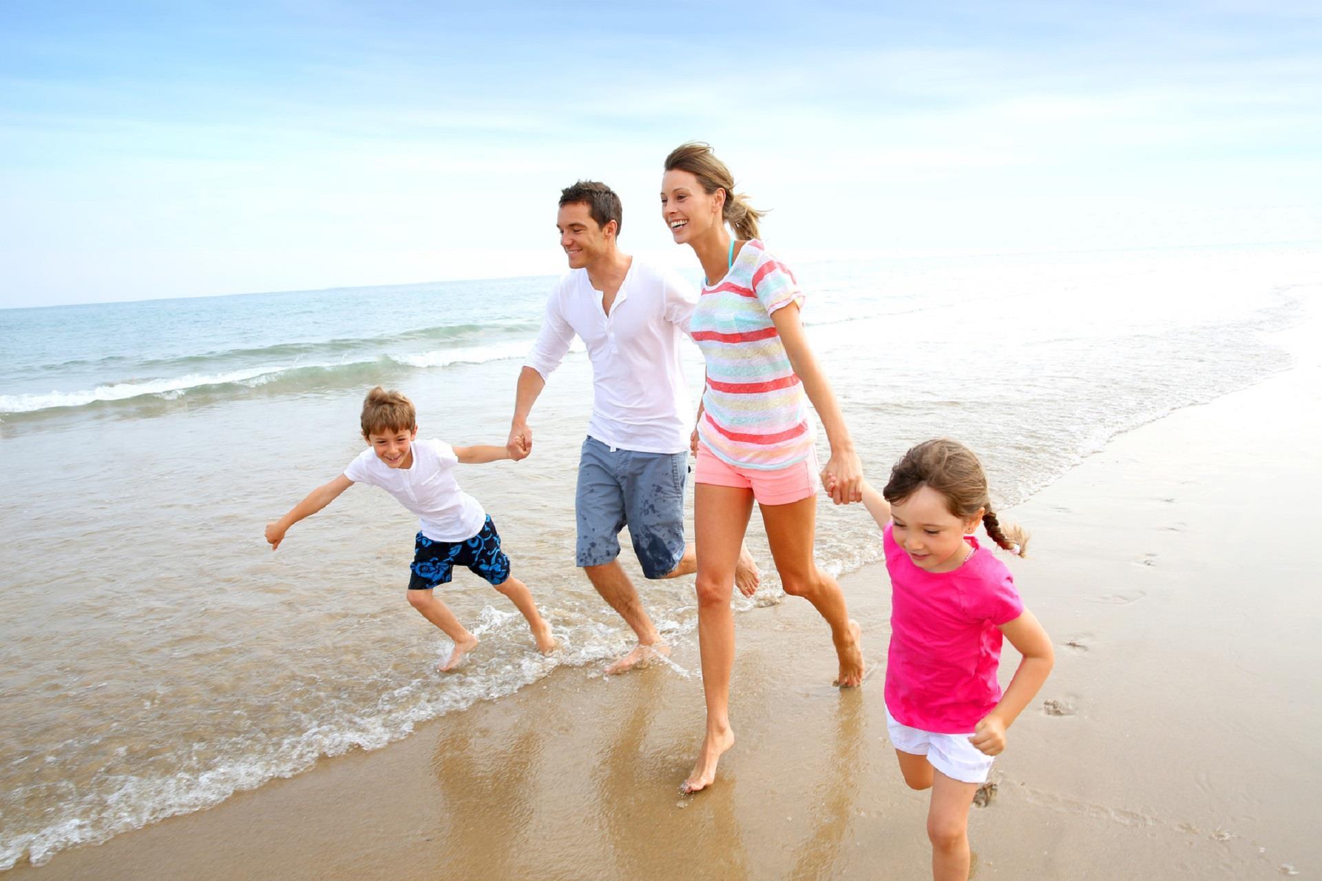A family plays on the beaches of Bald Head Island
