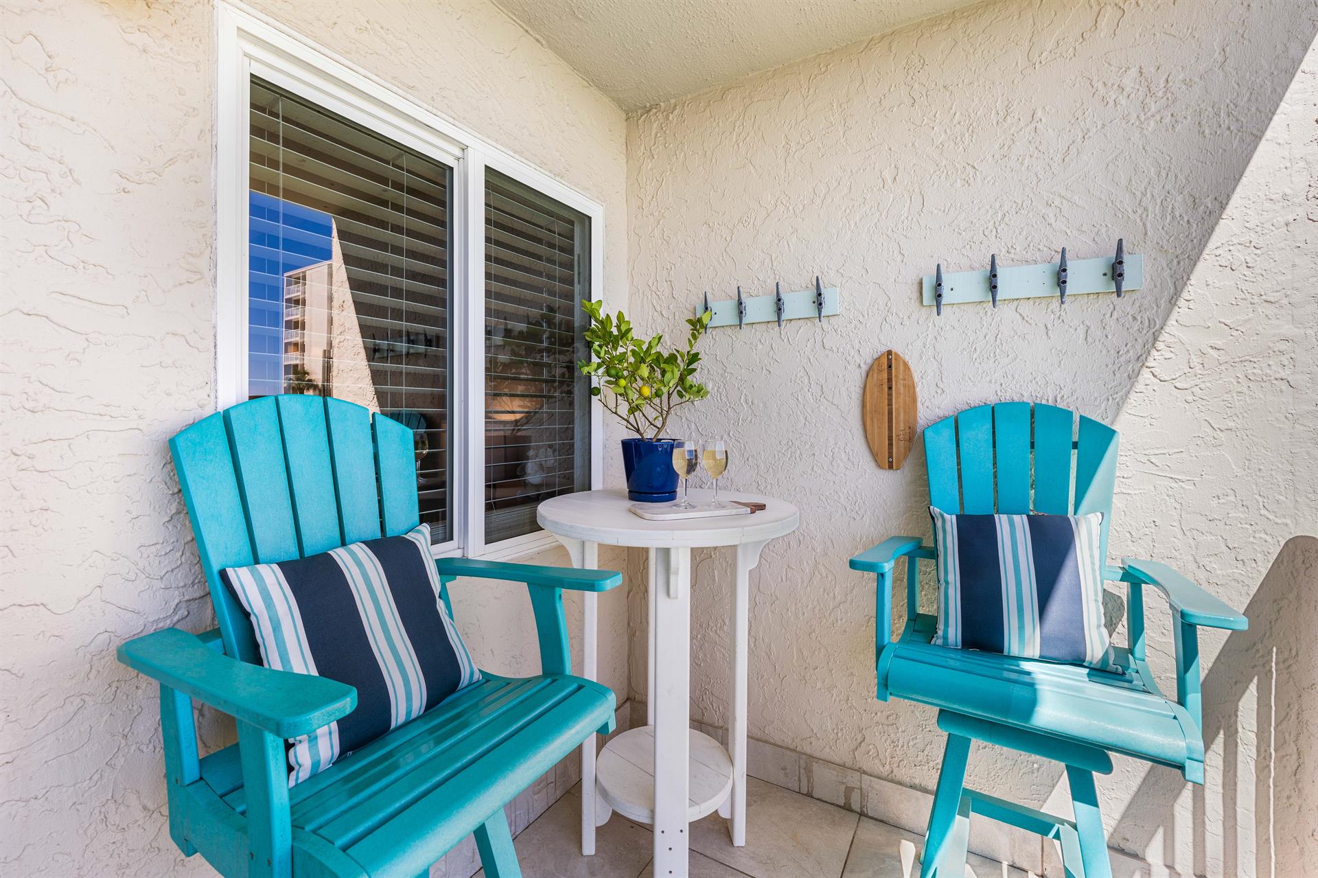 Relax outdoors in your private balcony with coastal charm.