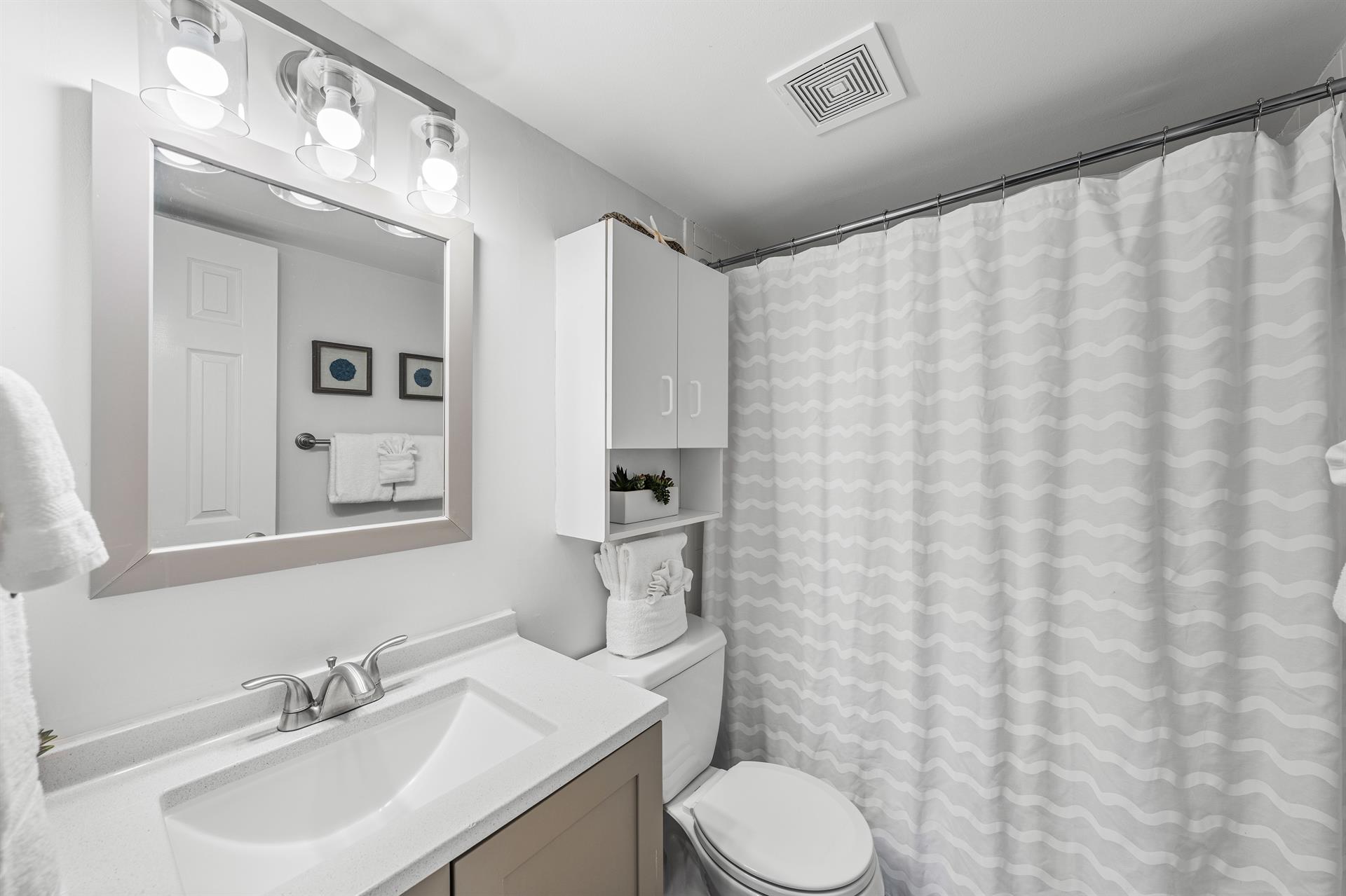 Full showertub and updated vanity make this bathroom vacationr