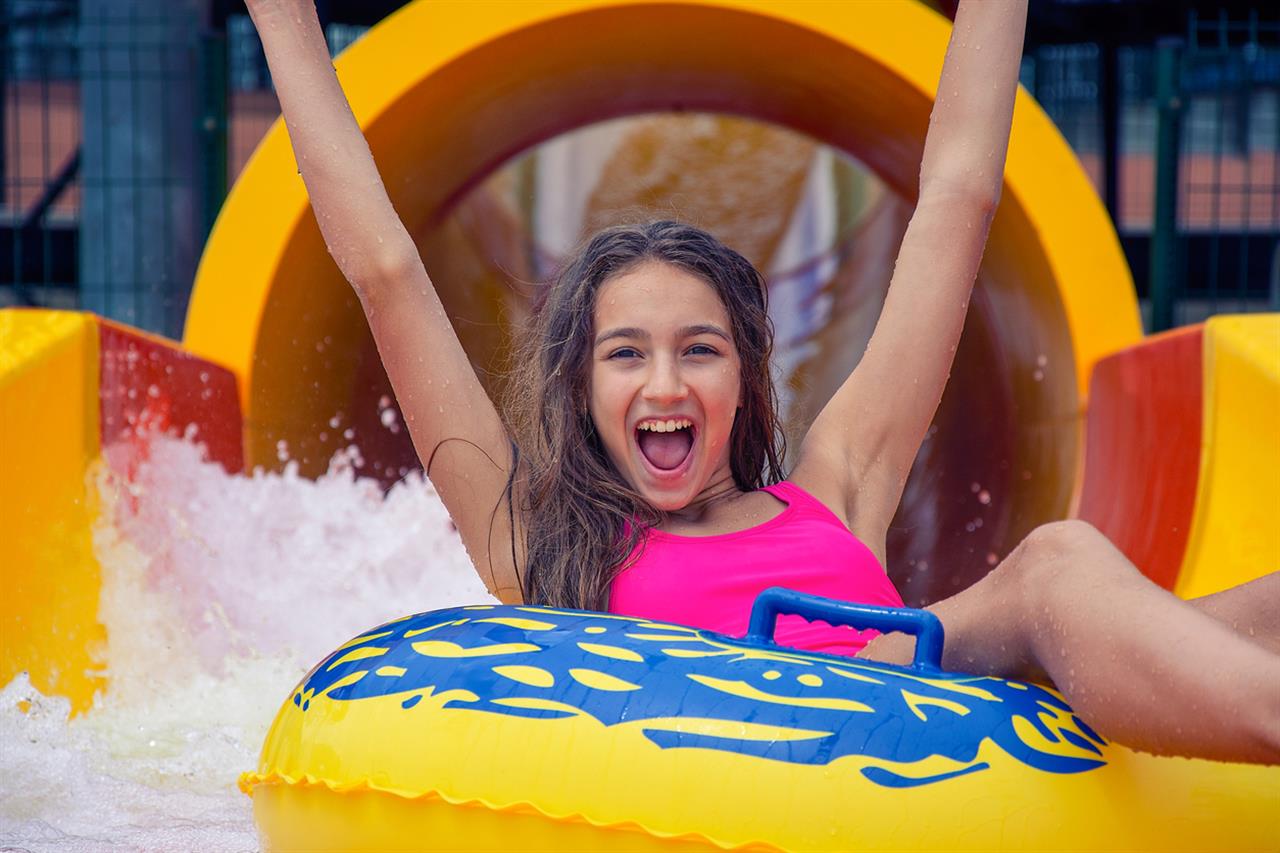 Young girl on water slide