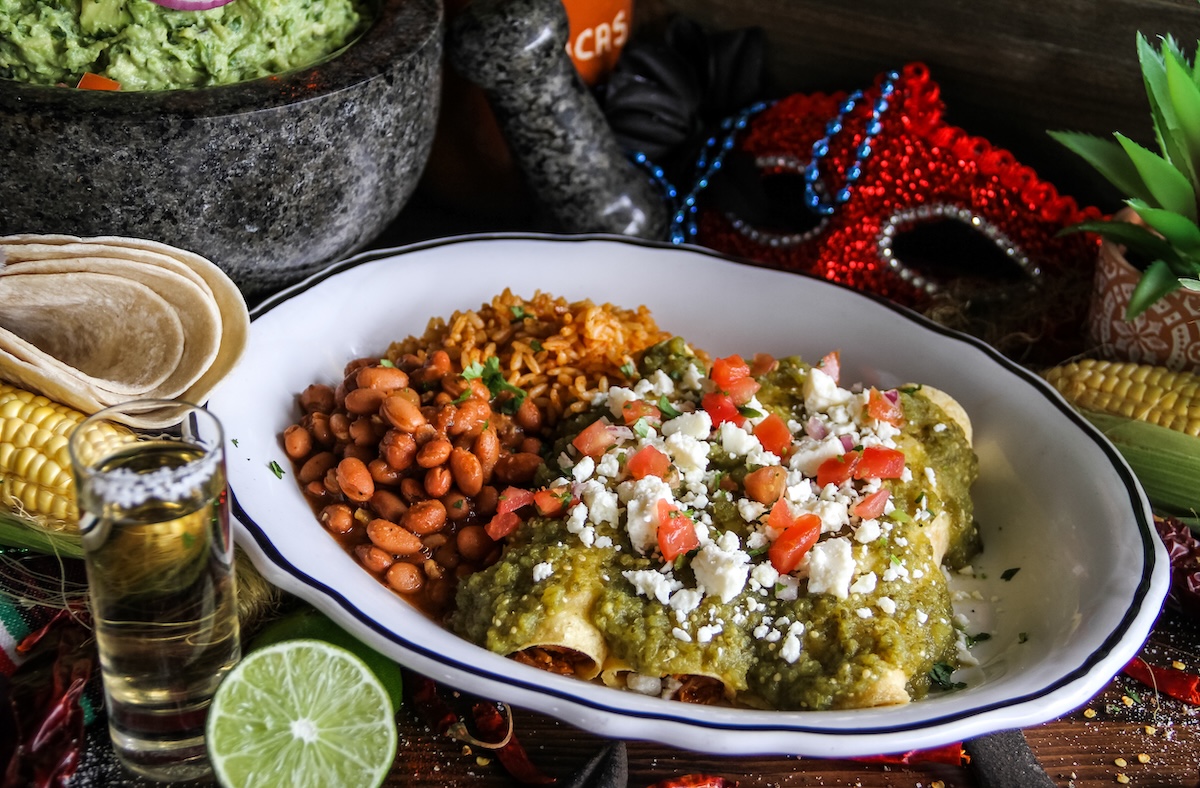 Enchilada verde with rice, beans, tortillas, guacamole, and lime from Dos Bocas for a Tex-Mex pool party at Cinnamon Shore