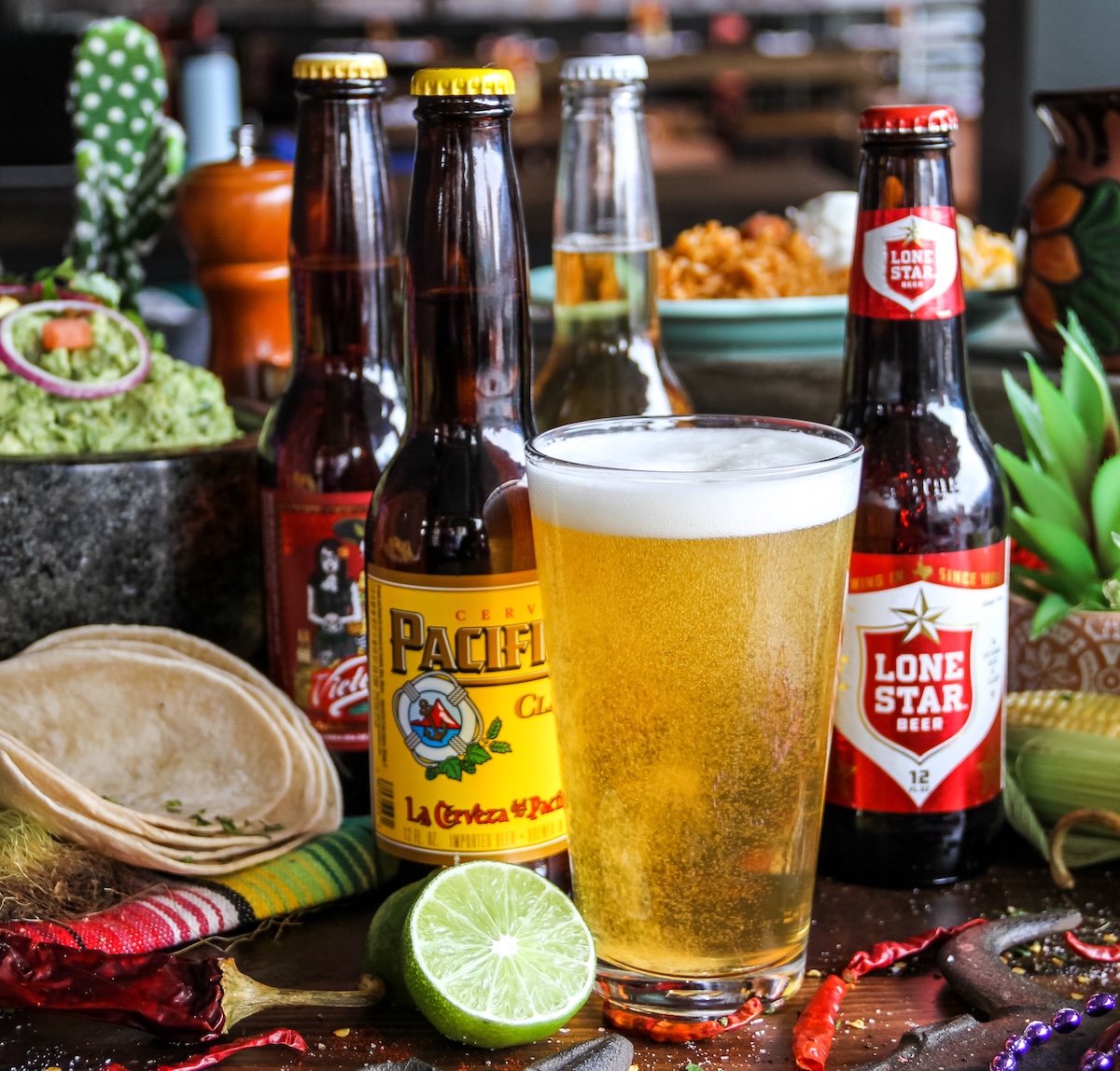 Beer, lime, tortillas, and festive Dos Bocas table setting for a Tex-Mex pool party at Cinnamon Shore in Port Aransas