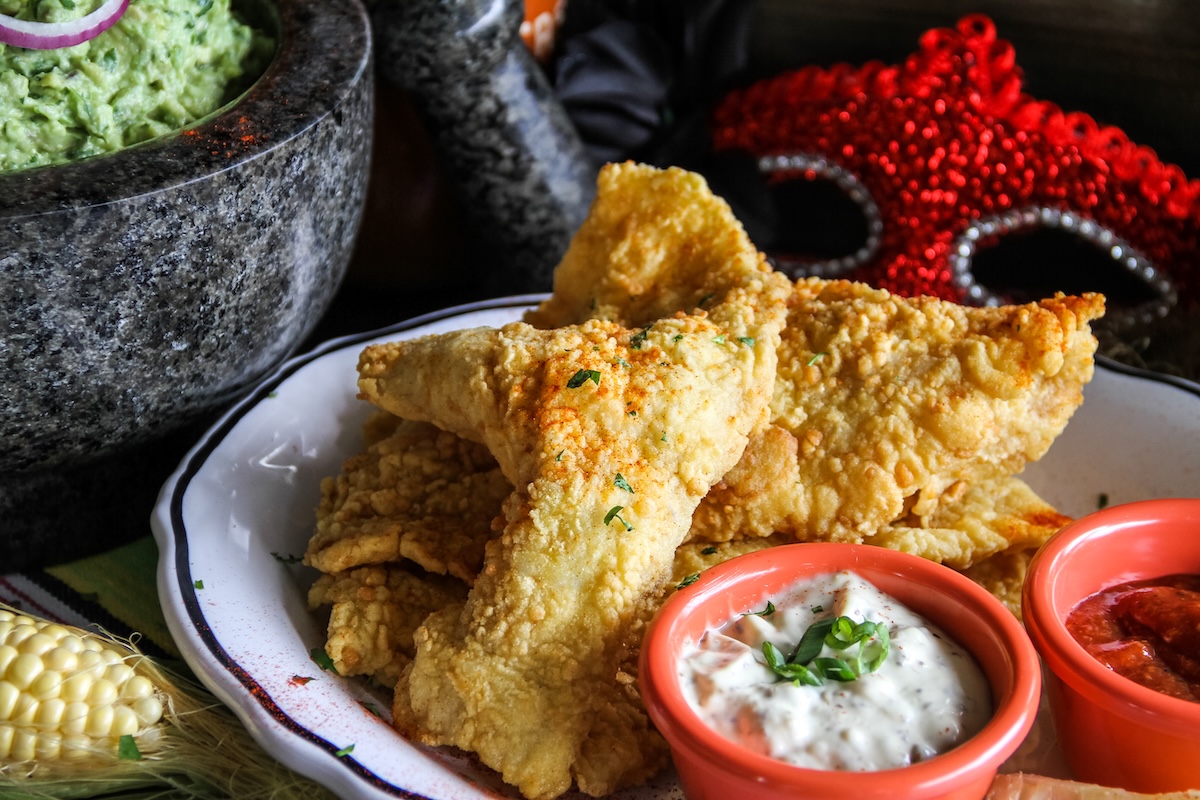 Crispy catfish with dipping sauces and guacamole from Dos Bocas for a coastal Cajun and Tex-Mex food preview at Cinnamon Shore