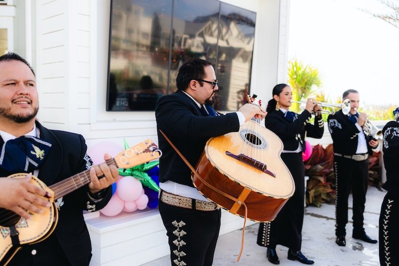 Close-up of mariachi band musicians playing guitar and trumpet at the Fiesta by the Shore event at Cinnamon Shore in Port Aransas, Texas