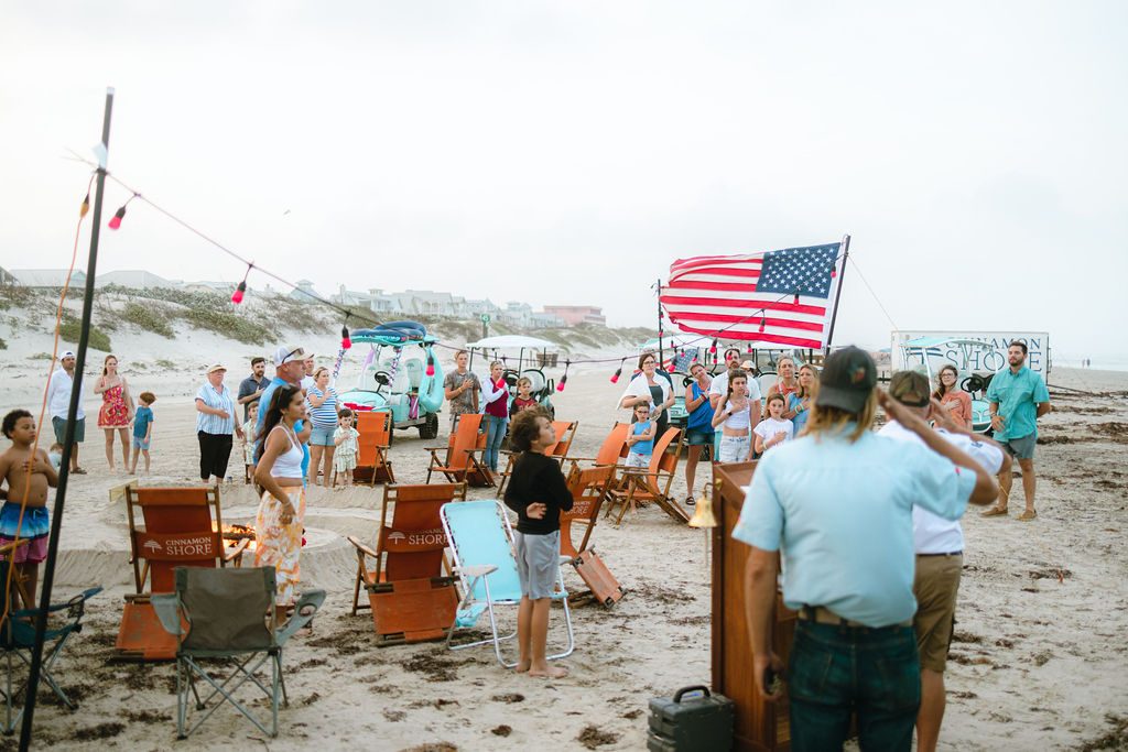 Cinnamon Shore community members and families gathered on the beach to salute the American flag during the Memorial Day ceremony in Port Aransas, Texas
