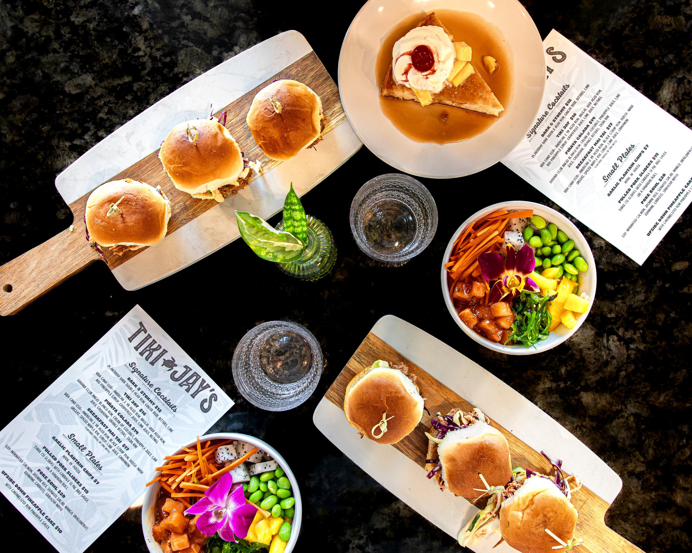 Tiki Jay's food and drink spread with poke, sliders, and small plates, now open at Cinnamon Shore