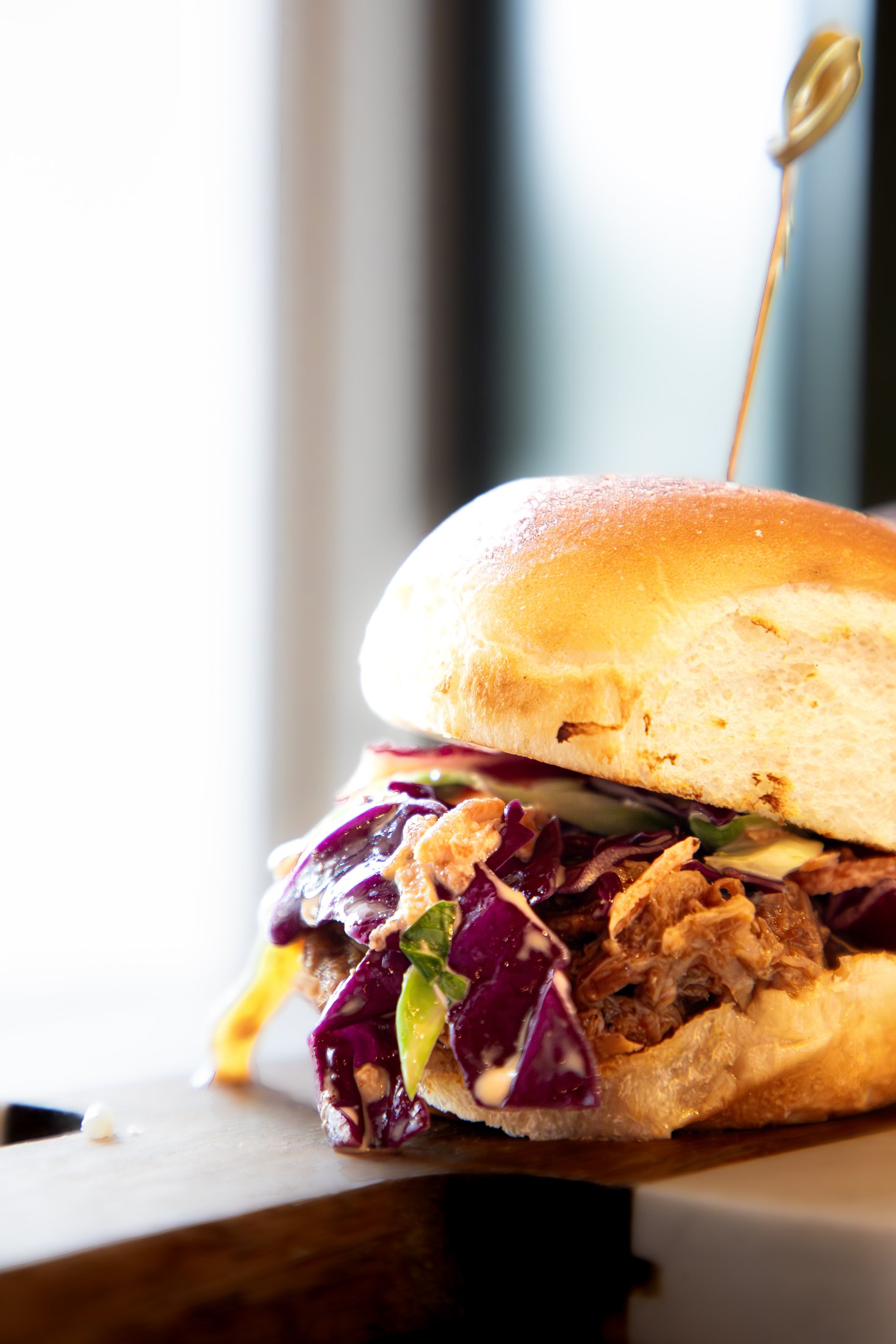 Tiki Jay's slider with colorful island slaw, part of the seafood and snack menu at Cinnamon Shore