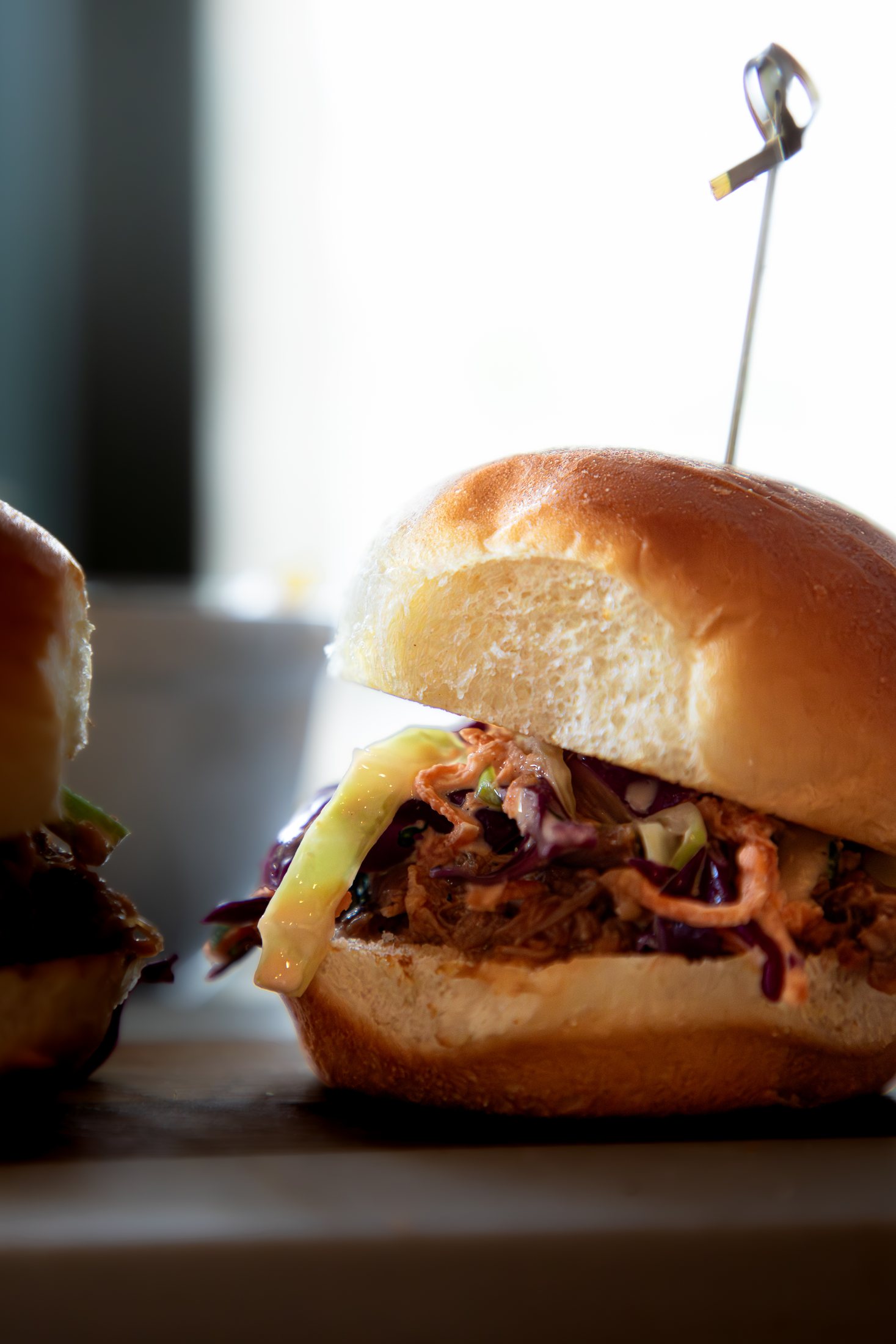Close-up of a Tiki Jay's pulled pork slider with island slaw at Cinnamon Shore