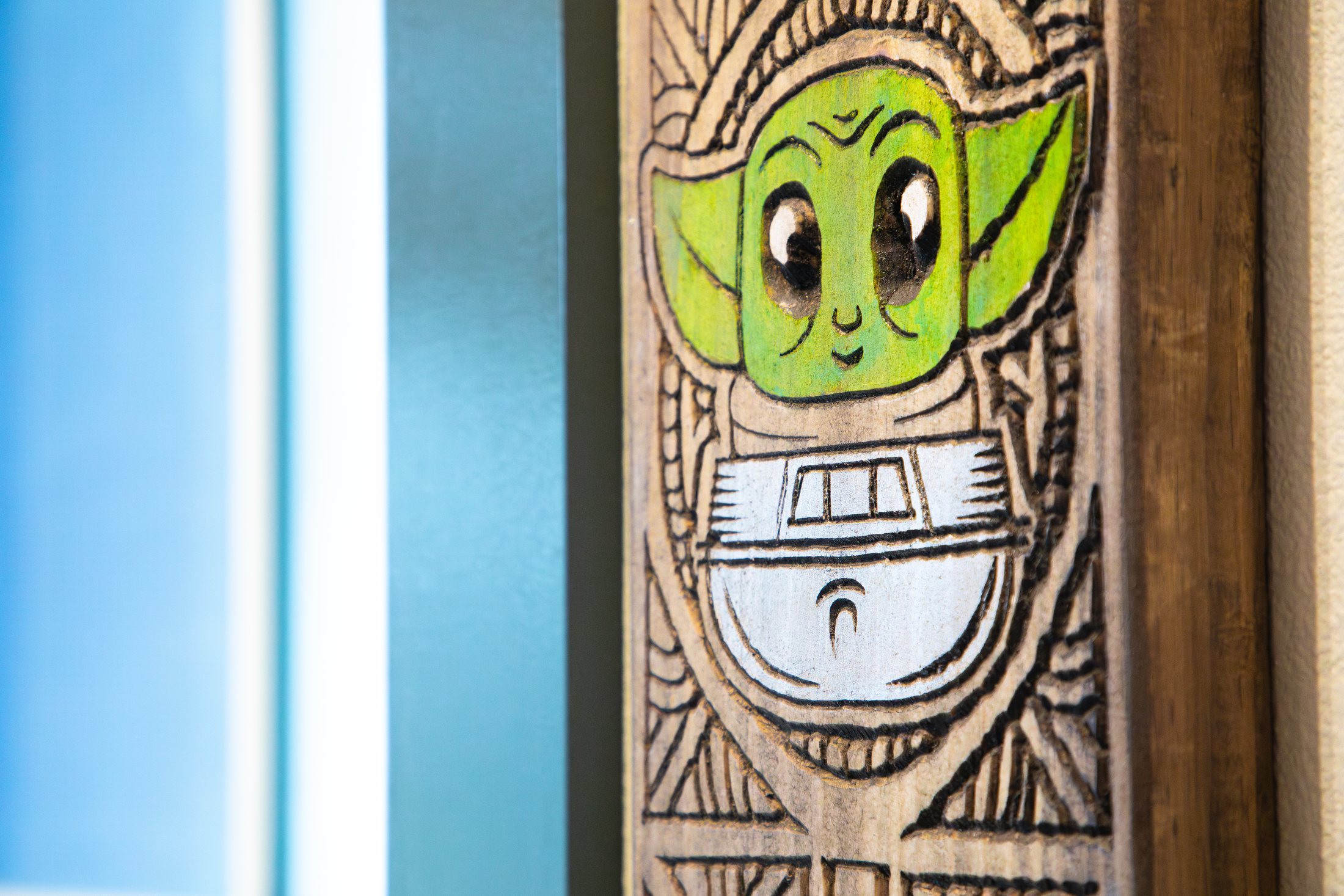 Close-up of carved tiki wall art at Tiki Jay's at Cinnamon Shore