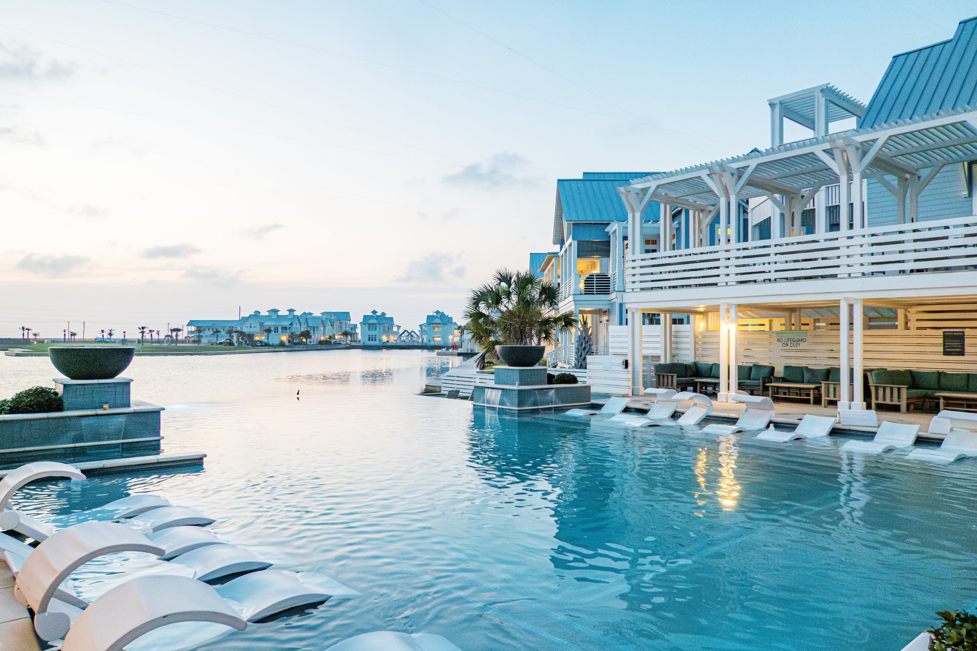 Cabana Pool at Cinnamon Shore South at sunset with lake views and glowing coastal homes
