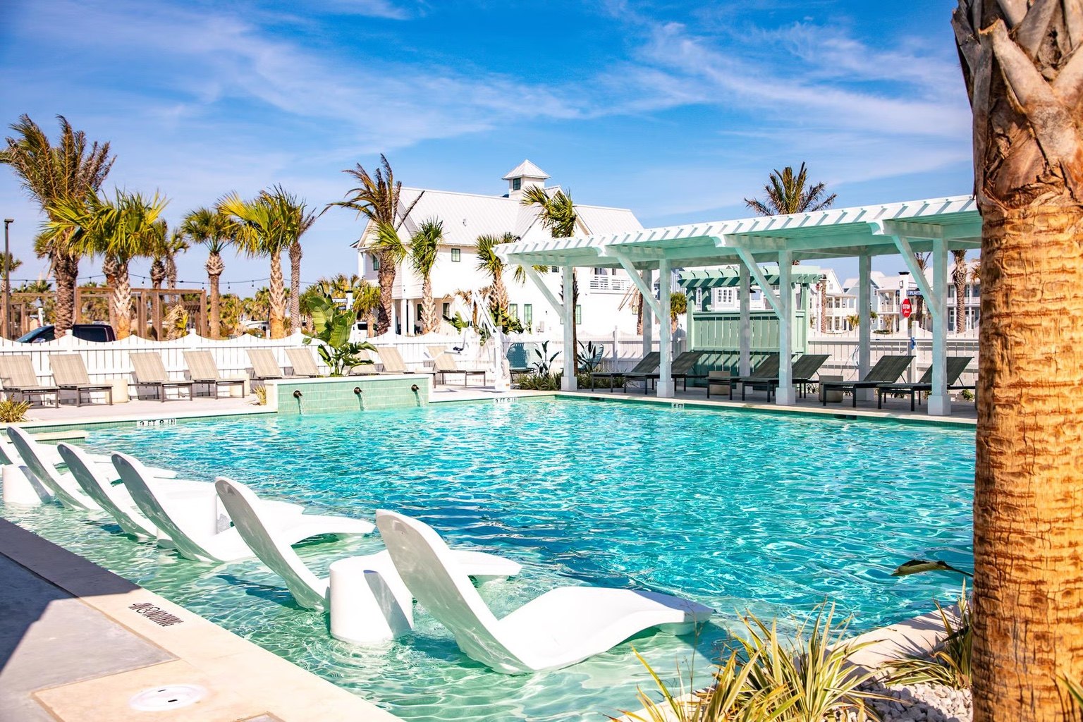 Sea Glass Pool at Cinnamon Shore South with loungers and coastal-style cabanas in Port Aransas, Texas