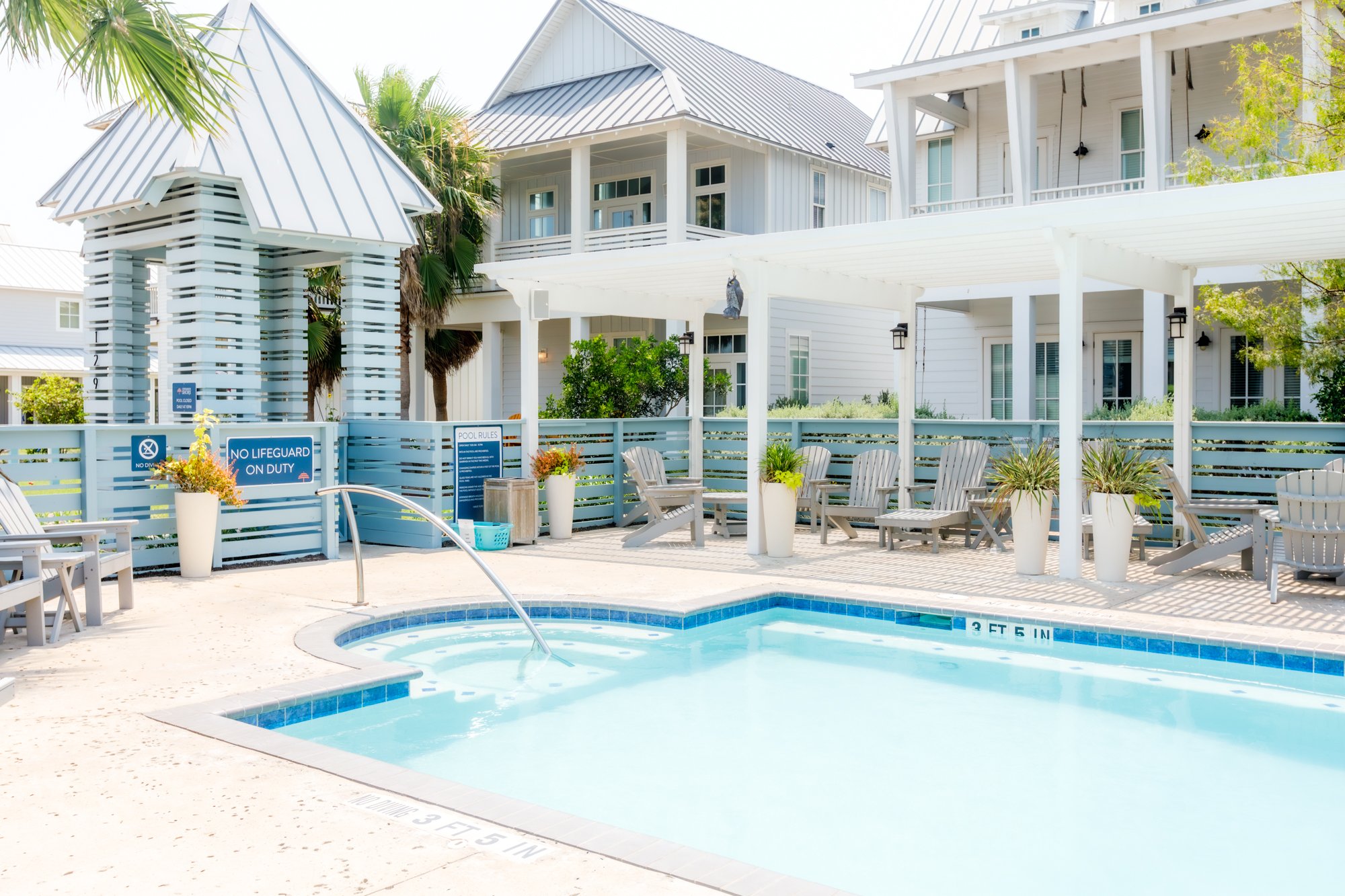 Still Water Pool at Cinnamon Shore North in Port Aransas, Texas, with white cabanas and coastal homes