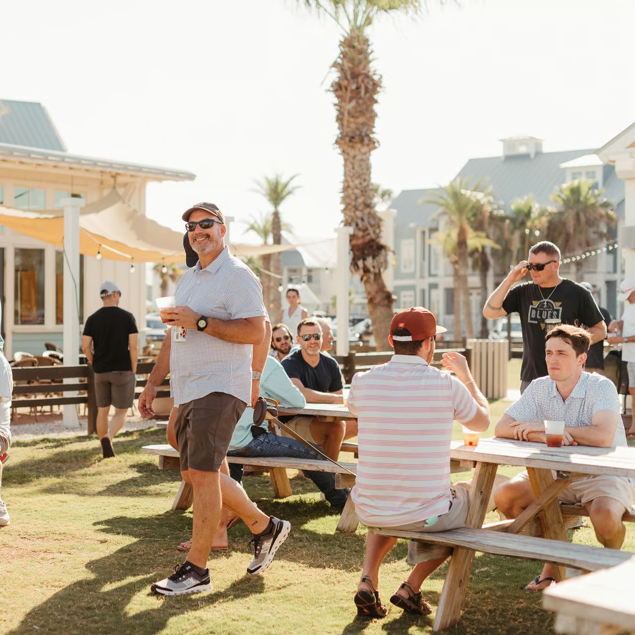 Group enjoying drinks and conversation outdoors at Cinnamon Shore Town Center during a corporate retreat in Port Aransas, Texas
