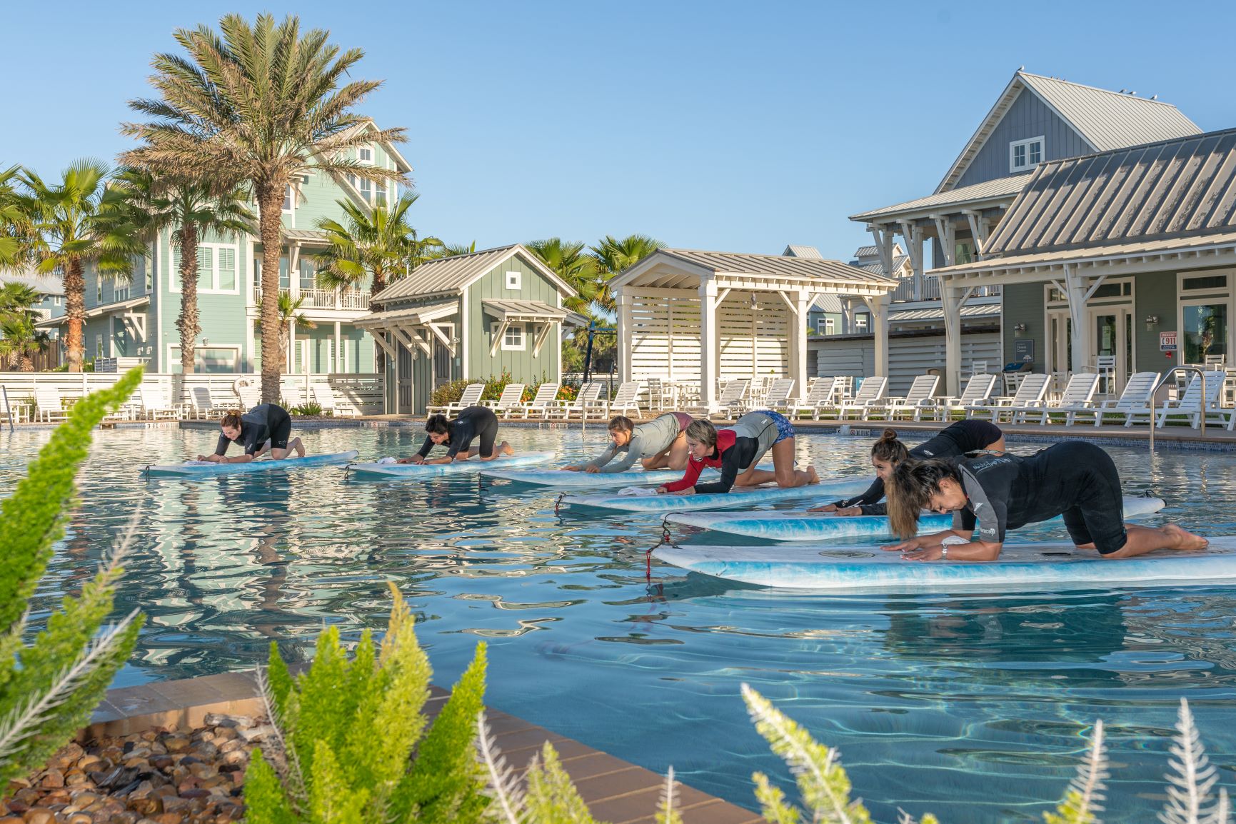 Paddleboard yoga class on the water at Dune Pool at Cinnamon Shore in Port Aransas