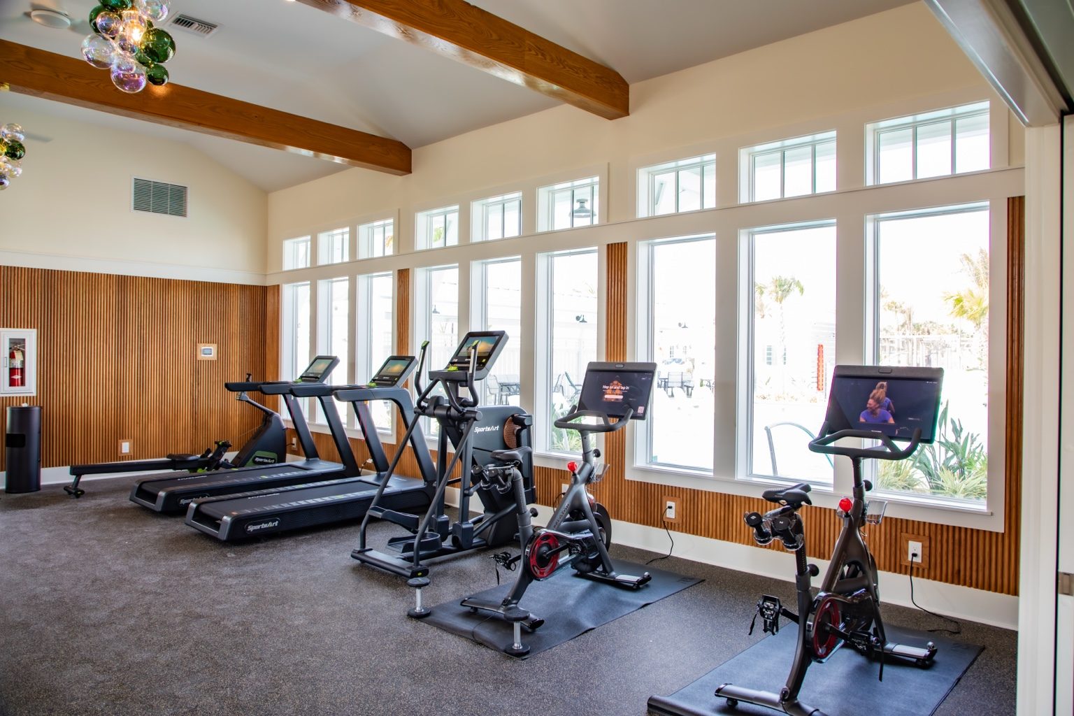 Sea Glass Fitness Center cardio room with treadmills and exercise bikes overlooking Cinnamon Shore.