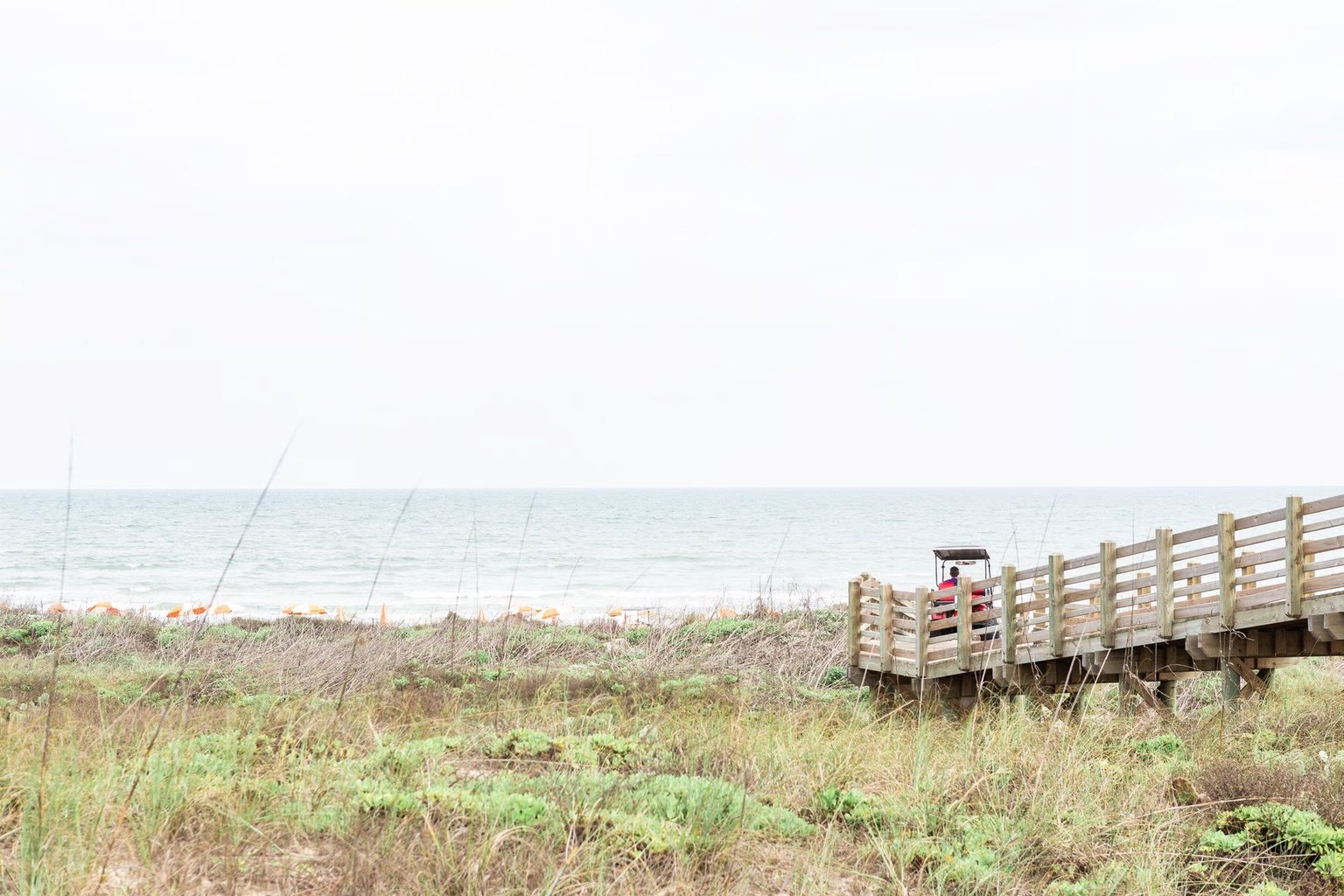Golf cart at a dune crossover to the beach at Cinnamon Shore in Port Aransas, Texas