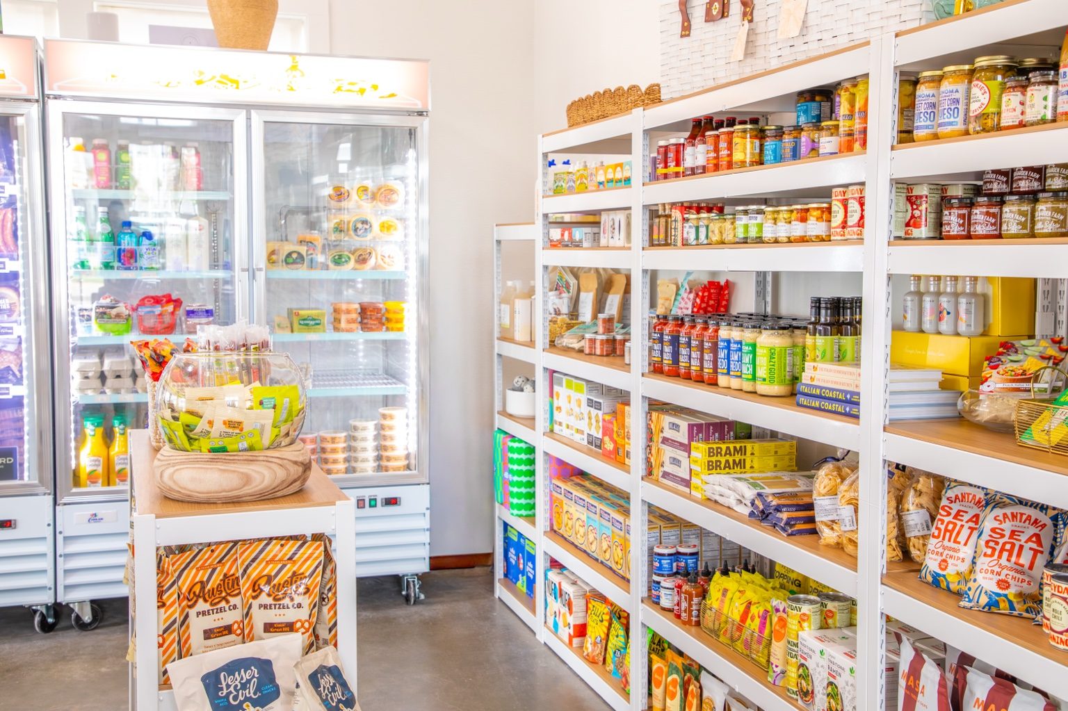 Gourmet pantry shelves and cooler items at Saltwater Gypsies Market at Cinnamon Shore