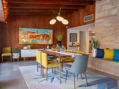 midcentury modern dining area with yellow covered chairs