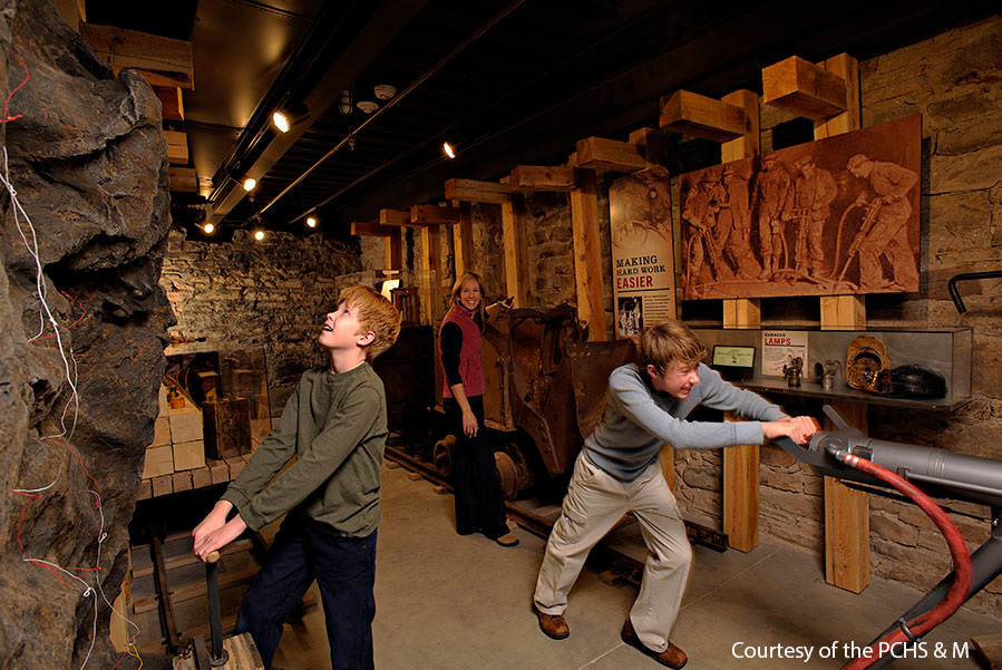 Two young boys playing with interactive exhibits at the Park City Museum.