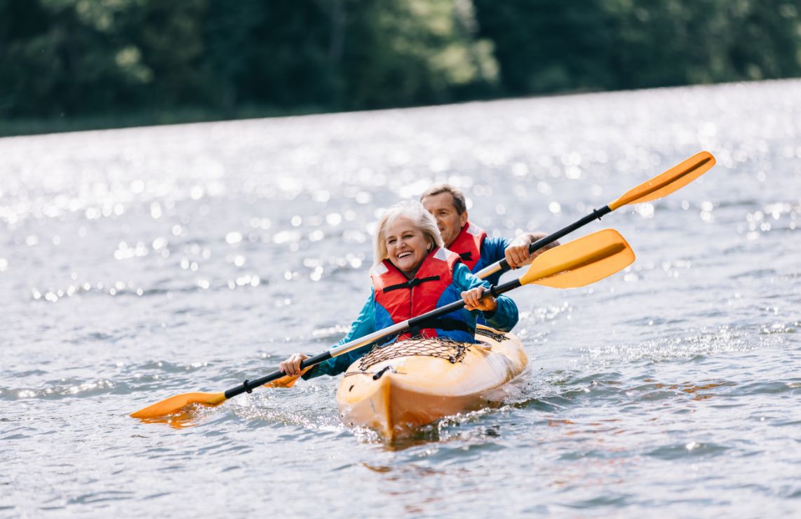 A woman and a man in a yellow kayak.
