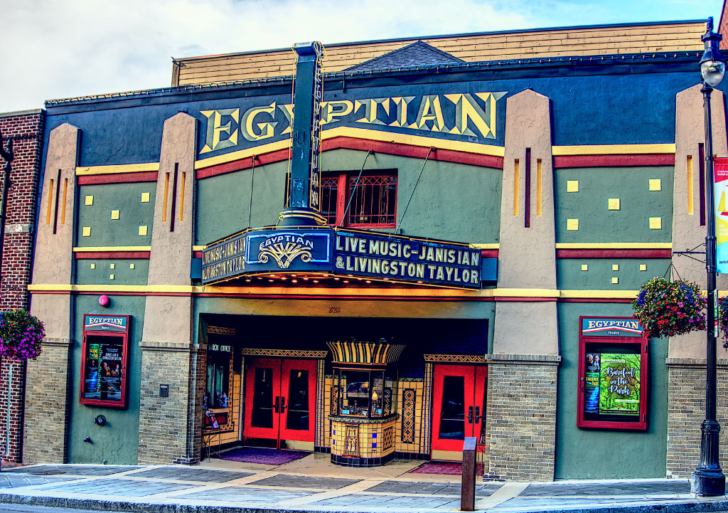 The outside of the Egyptian Theatre in Park City, a blue and green building with red trim.