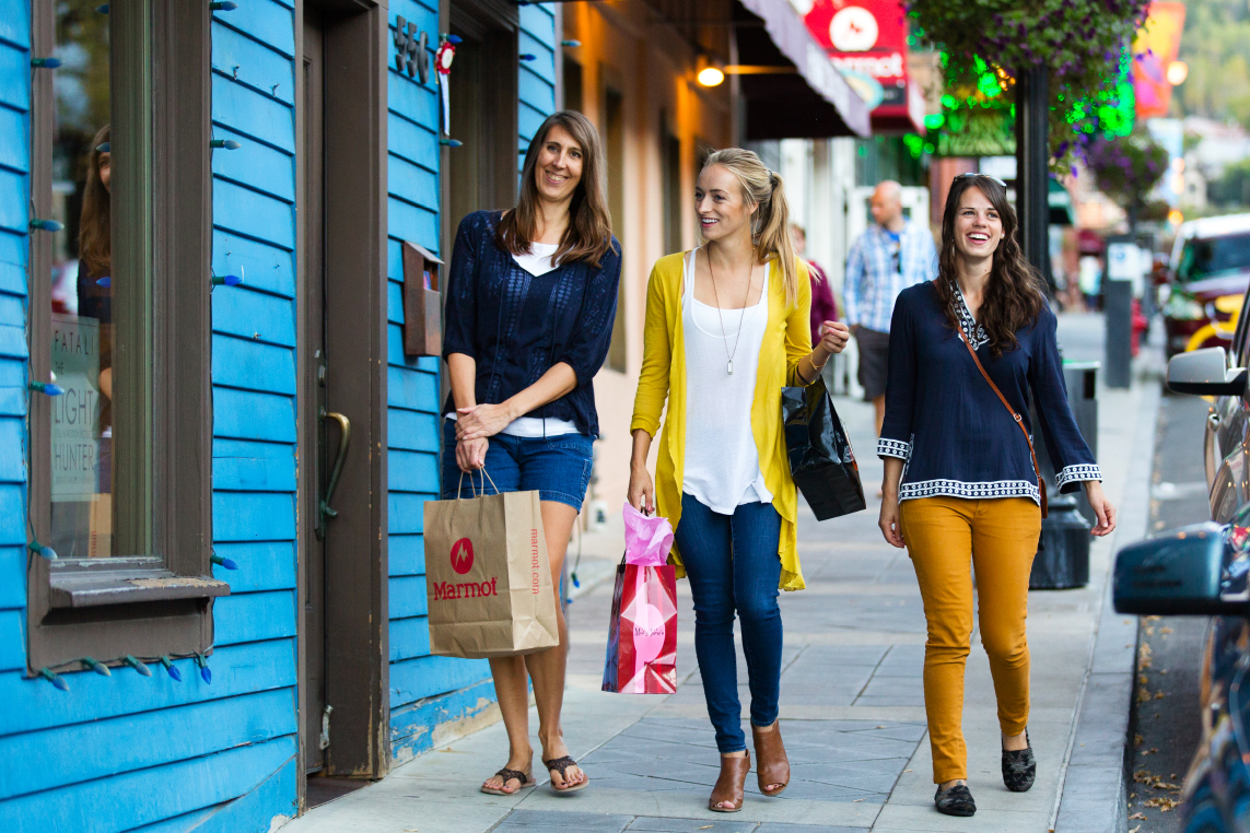 Three women shopping and strolling on Main Street, Park City.