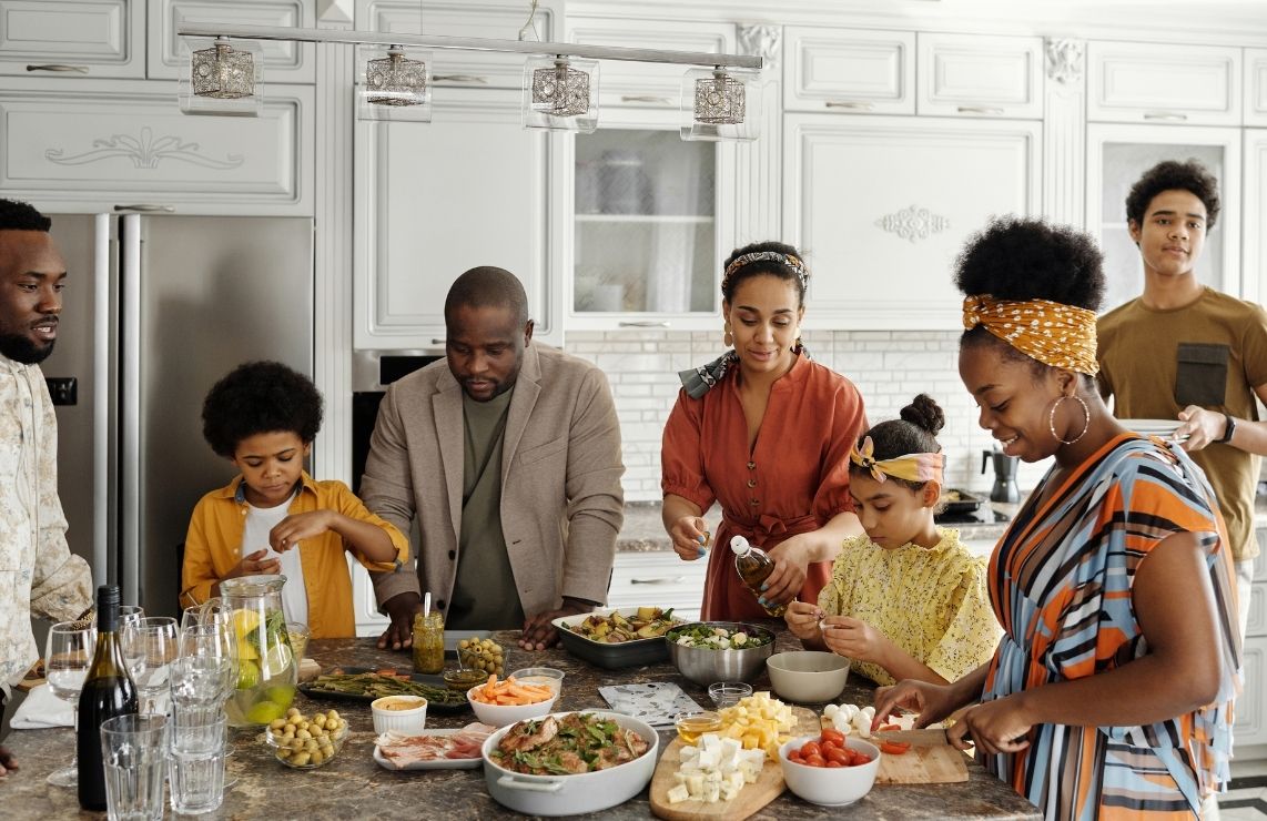 A big family making a meal in a vacation rental in Park City.