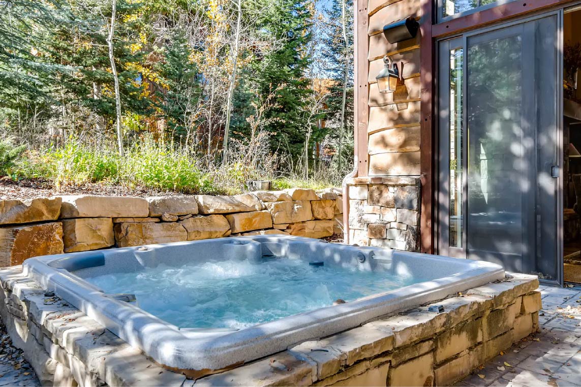 Private hot tub behind a luxury vacation rental home in Park City, Utah.
