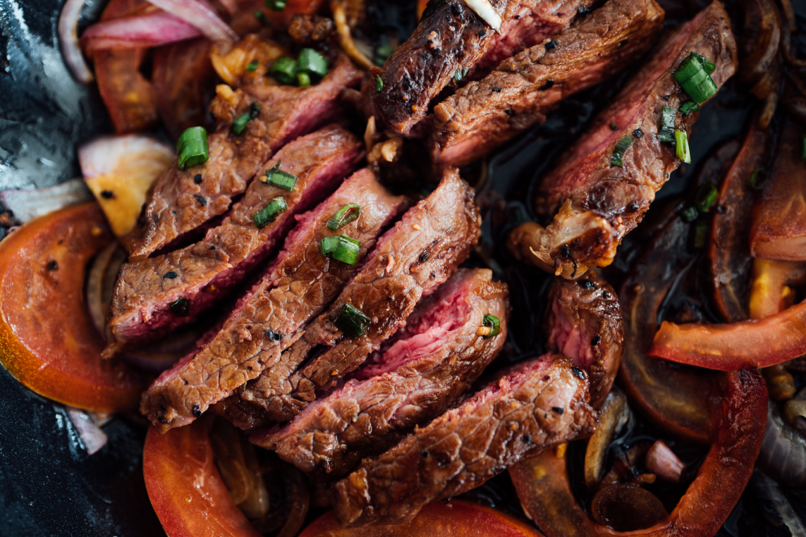 A plate of sliced medium-rare steak with veggies to make your own fajitas at Chimayo, a restaurant in Park City.