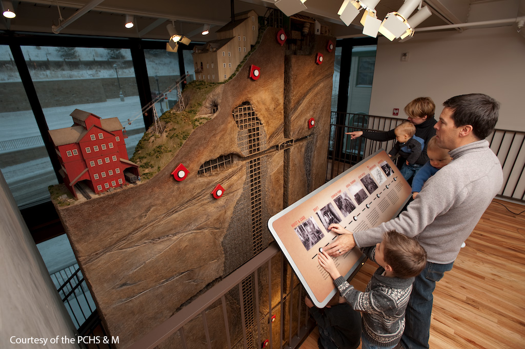 Family playing with interactive exhibits at the Park City Museum.