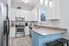 Fully Stocked Kitchen with Stainless Steel Appliances and Bar Seating for 2