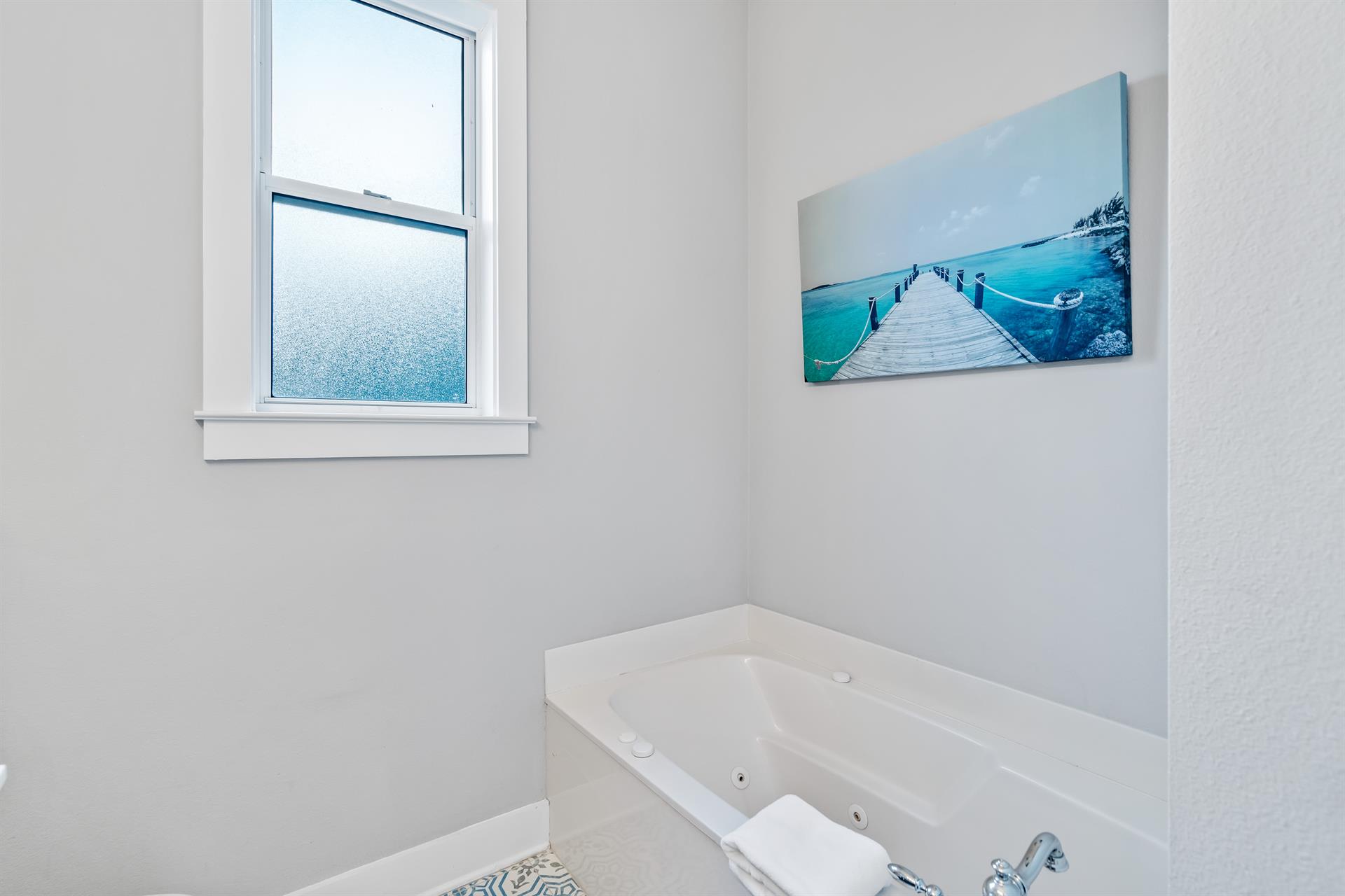 2nd floor ensuite bathroom for the primary king bedroom with double vanities, separate walkin shower,  soaking bathtub.