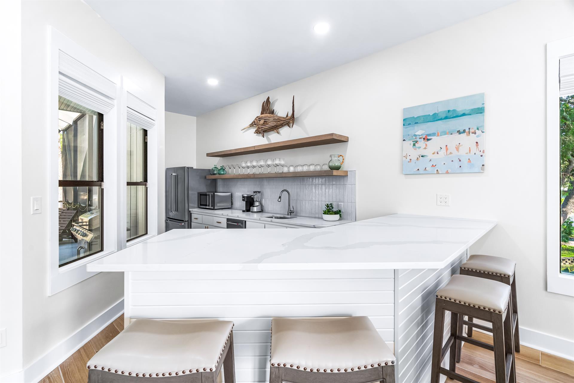 Full Size Living Room Bar with a Second Full Size Refrigerator and Free Standing Ice Maker and Wine Cooler, Microwave and Blender With Seating for 4 More