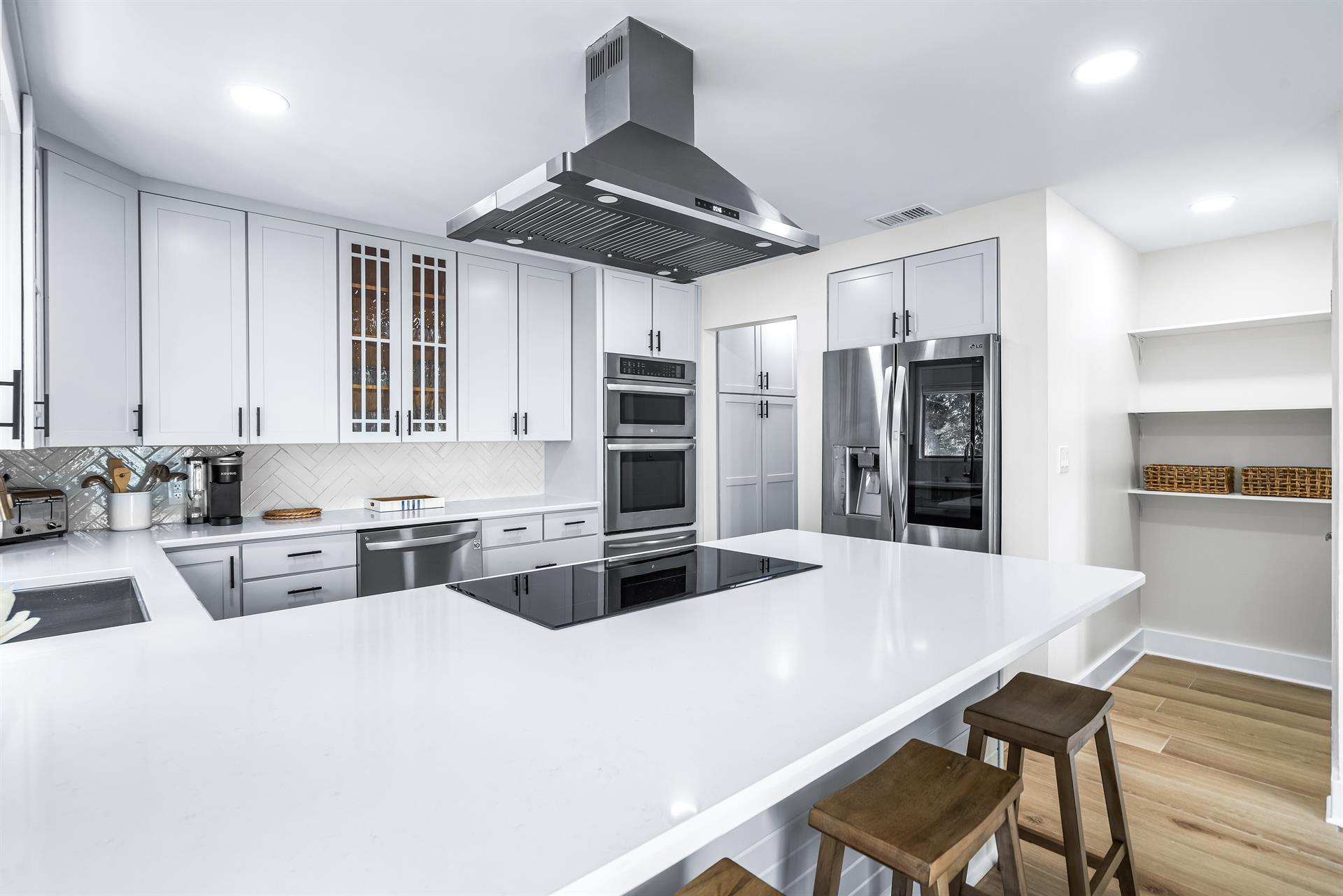 Fully Stocked Kitchen with New Quartz Counters and Bar Seating for 4