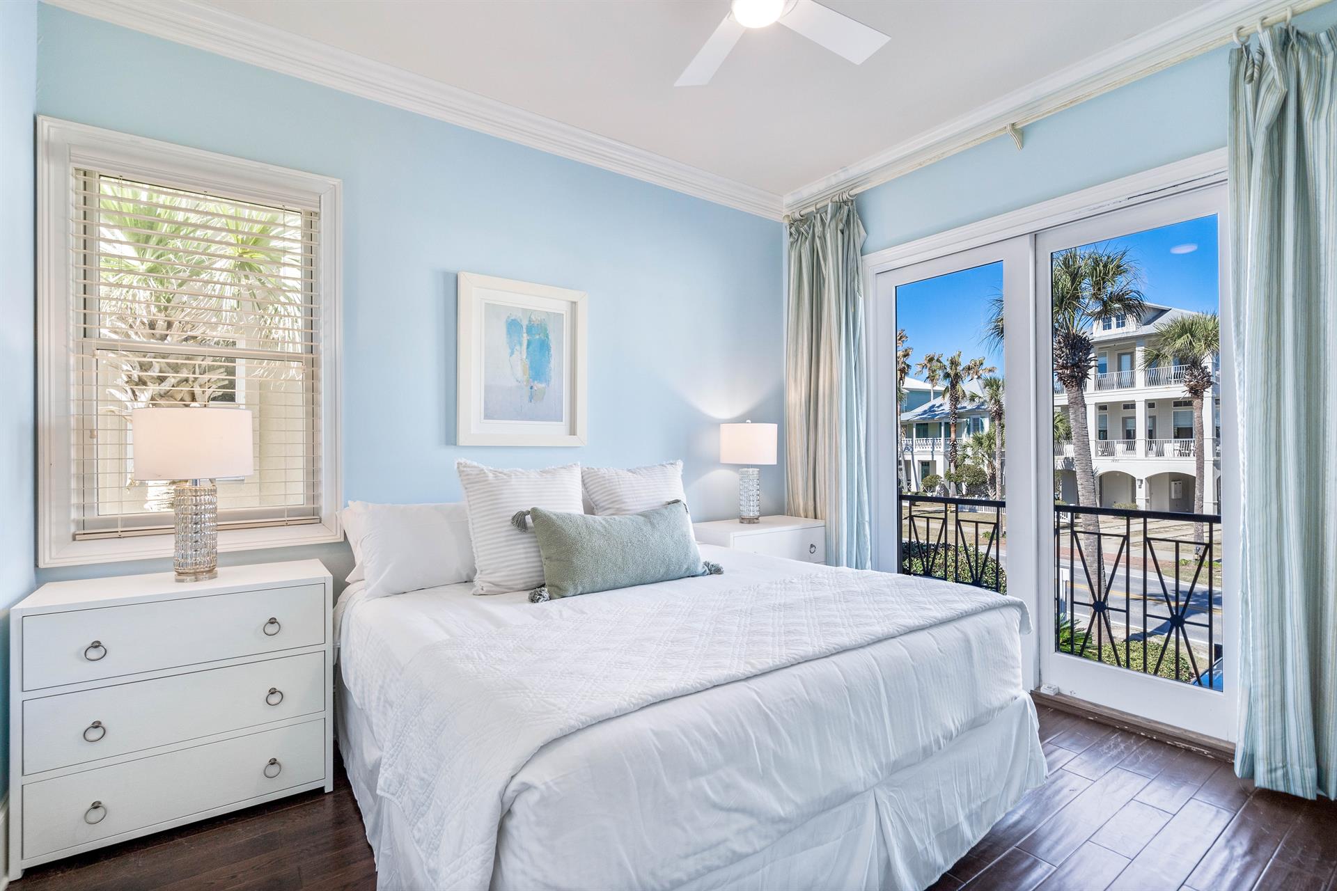 Second Floor Bedroom with king bed, ensuite bathroom, and balcony overlooking the Frangista Beach community.