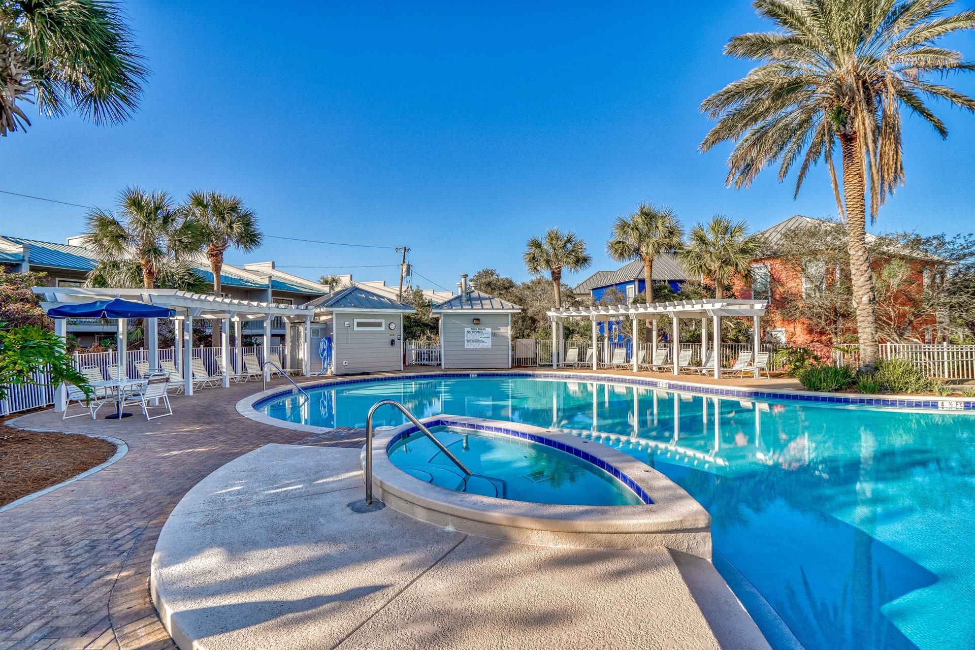 Families enjoy this spacious pool area with plenty of seating for sunbathing plus the heated spa and nearby grilling area.