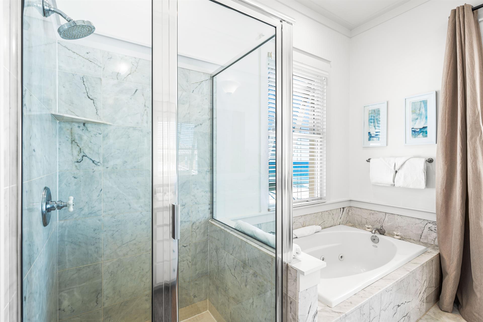 Walkin shower and a large jetted soaking tub in this primary beachfront bathroom.