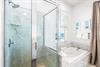 Walkin shower and a large jetted soaking tub in this primary beachfront bathroom.