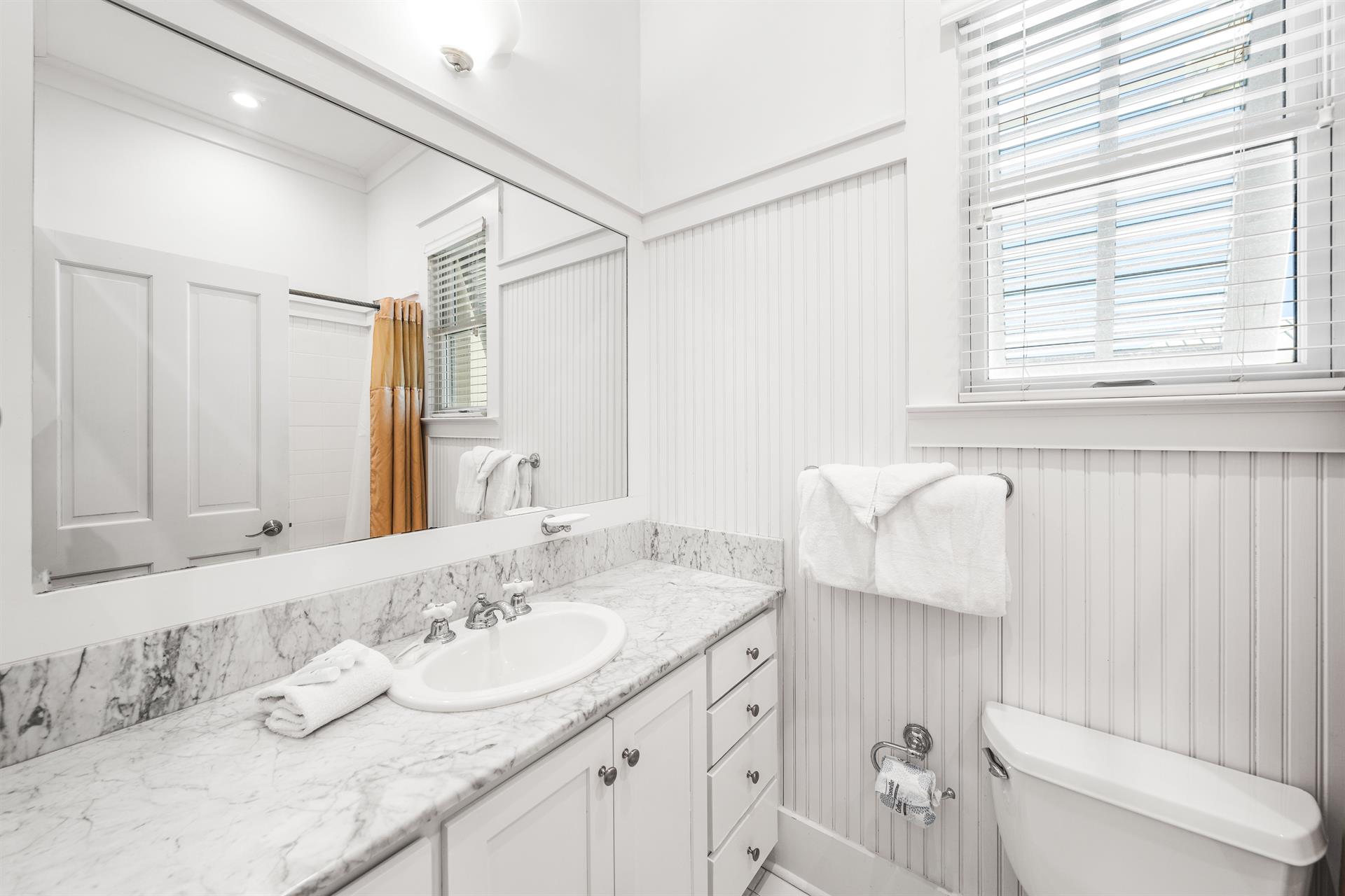 Ensuite bathroom for 3rd floor northeast queen  bedroom.  Marble vanity and bathtubshower combination.