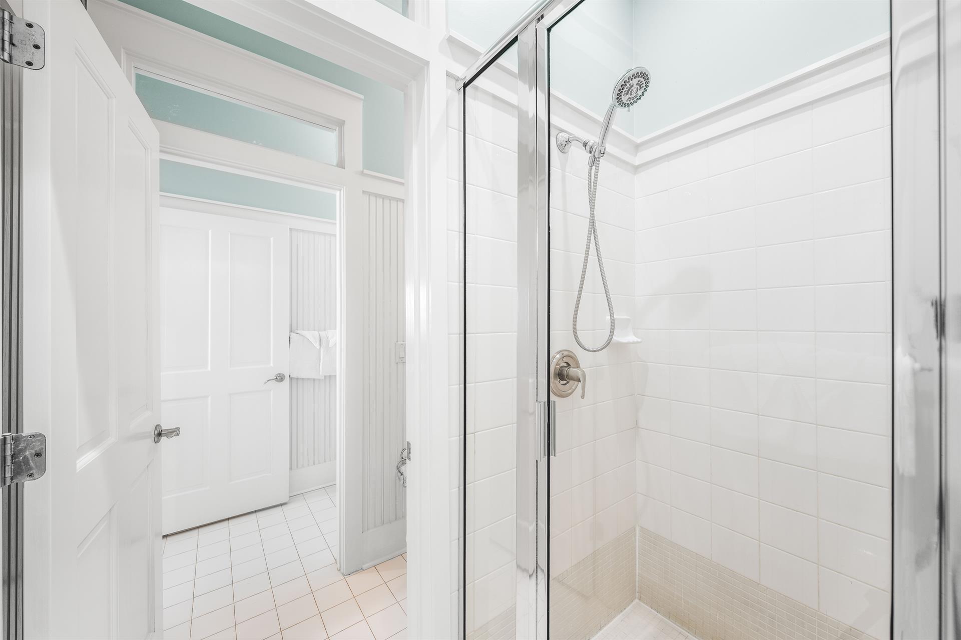 Sharing is caring between the two 1st floor bedrooms—especially when its this spacious shower bathroom Perfect for freshening up after a beach day.