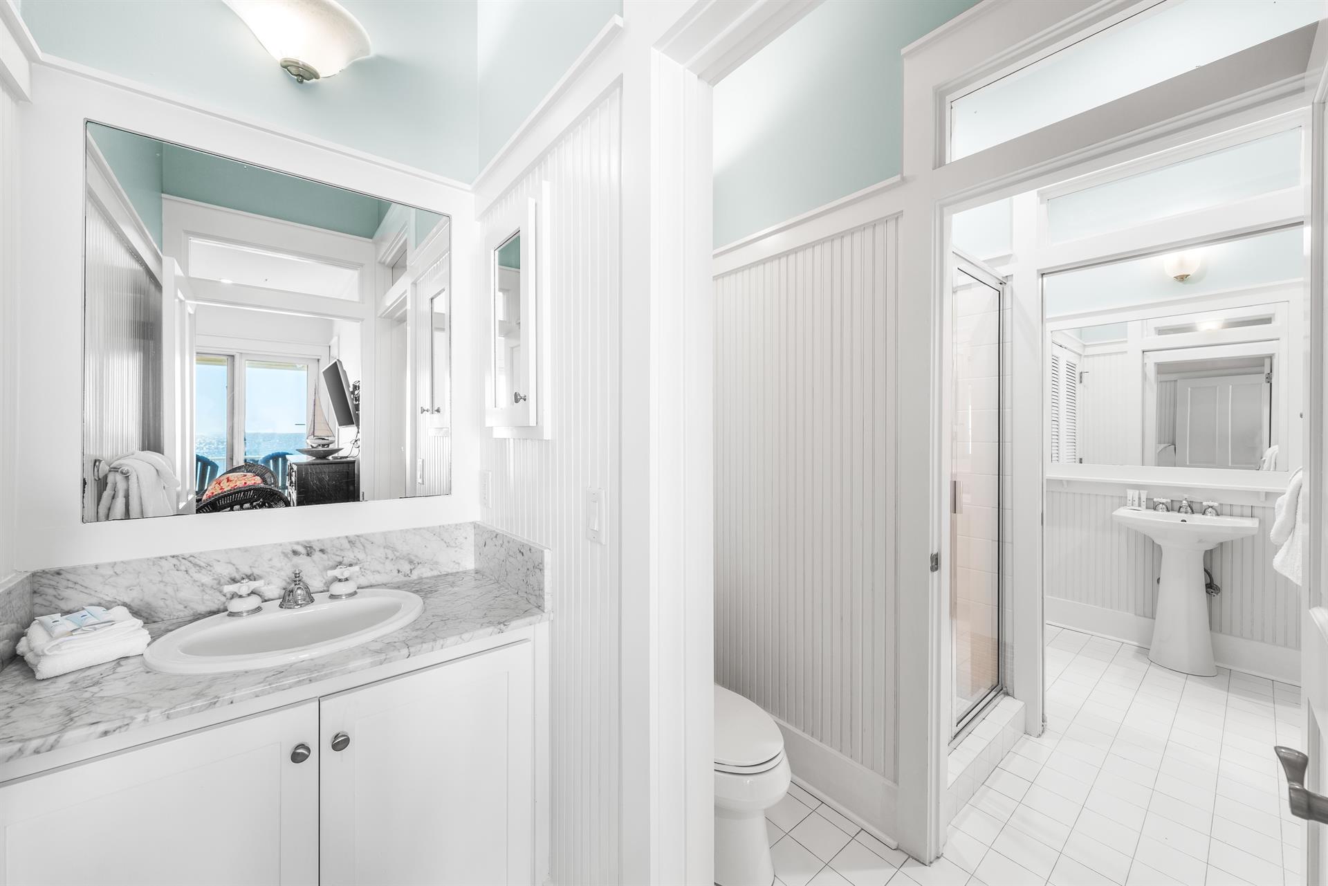 1st floor shared bathroom.   Doors between the sinkvanity, water closet, walkin shower, and a second pedestal sink dividing the bathroom into 3 private, usable spaces.