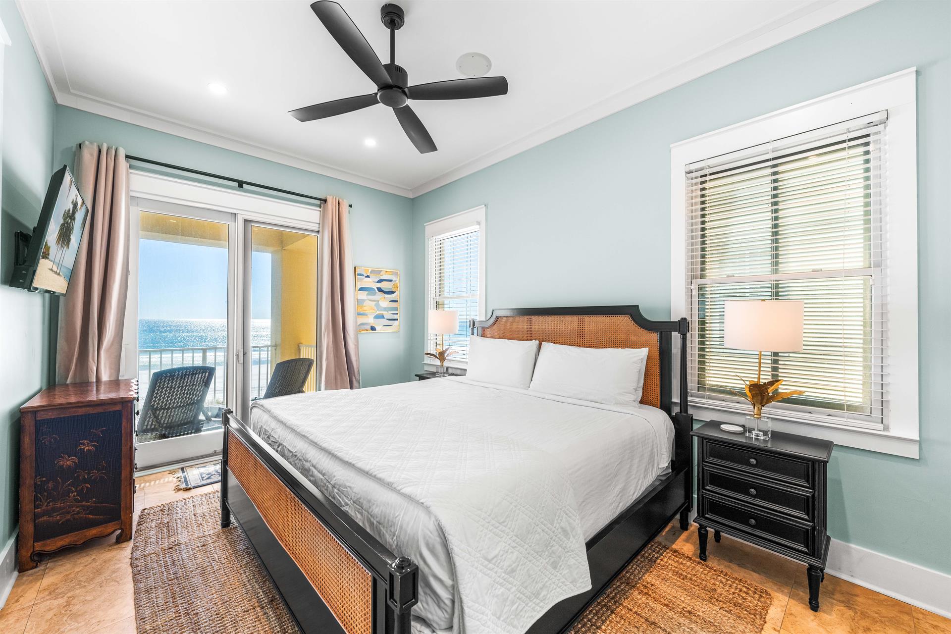 Beautiful beachfront king bedroom with views of the Gulf, 42 flat screen tv, balcony access, and your own wet bar with an additional Keurig coffee maker set up, beverage cooler, and ice maker.