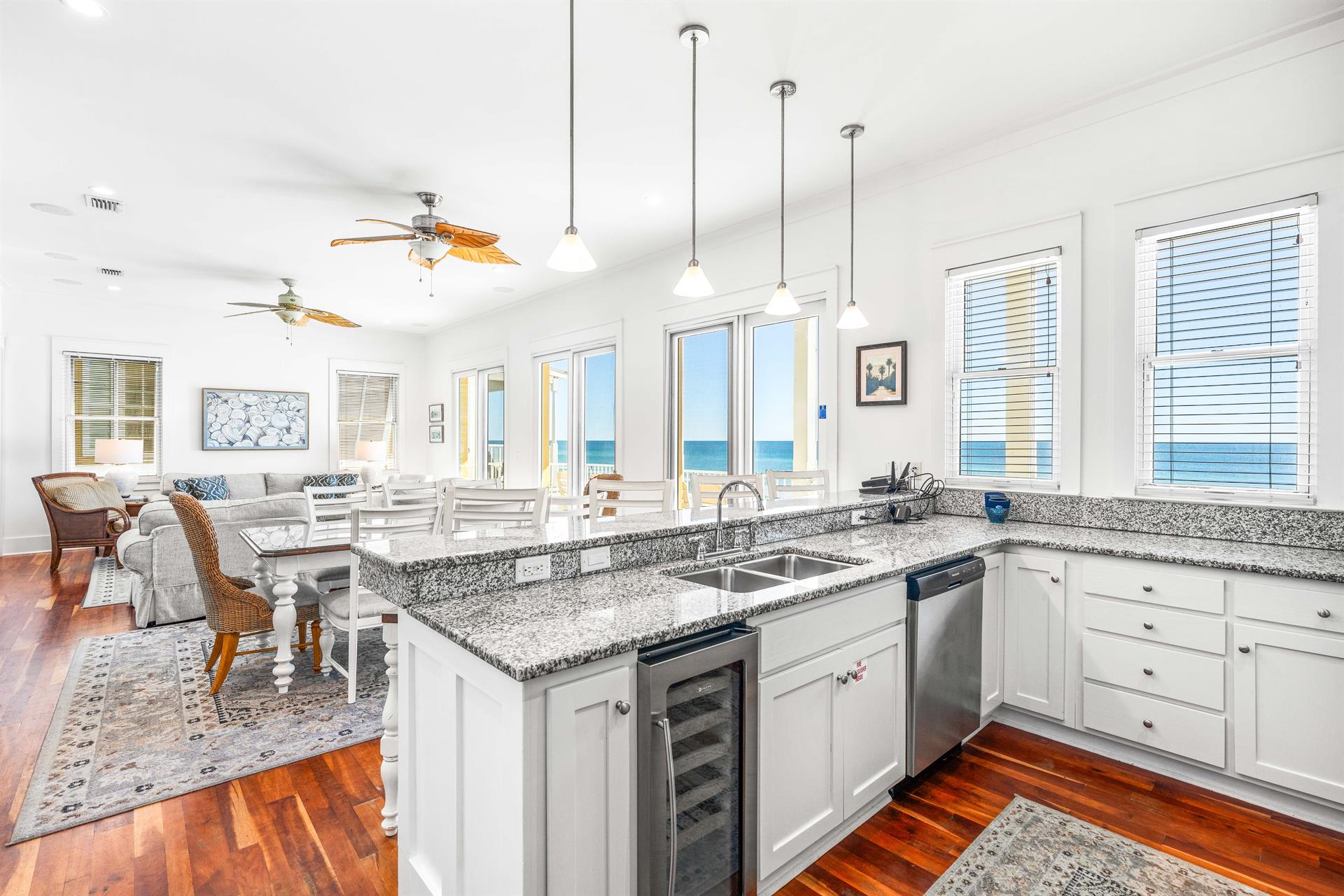 Open kitchen on the 2nd floor level great room with stainless steel double sinks, wine cooler, dishwasher  granite countertops.