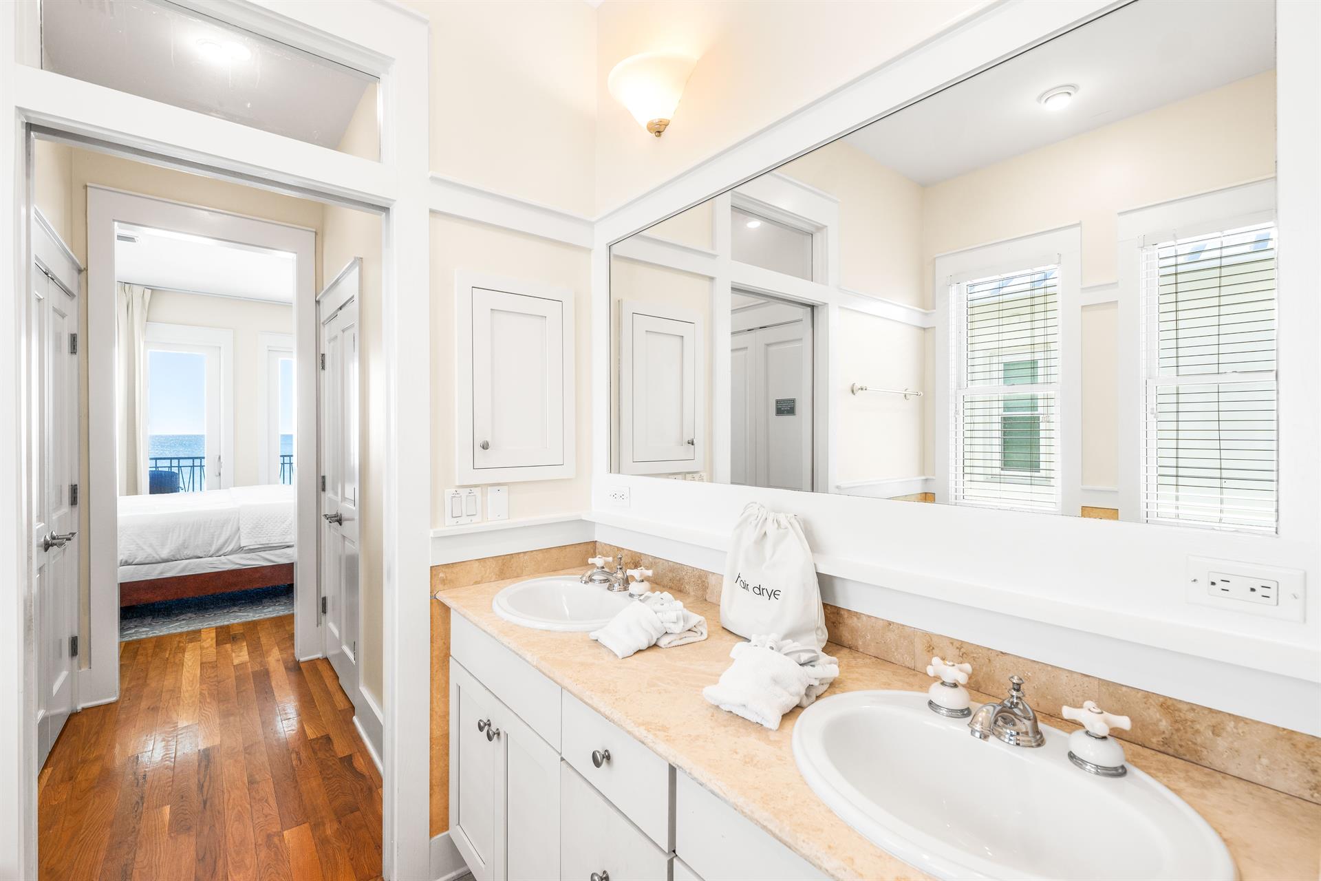 Dual Travertine Vanities with a Separate WalkIn Shower and Soaking Bathtub for the Primary 3rd Floor bedroom.