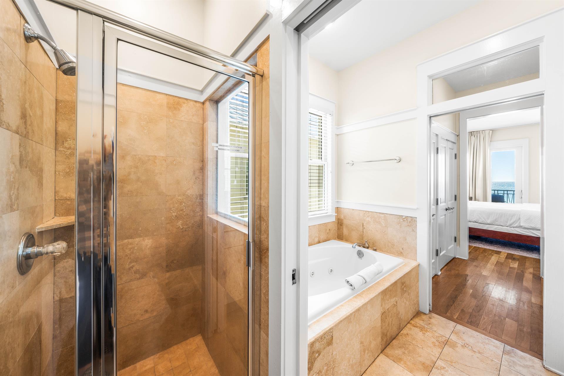 Dual Travertine Vanities with a Separate WalkIn Shower and Soaking Bathtub for the Primary 3rd Floor bedroom.