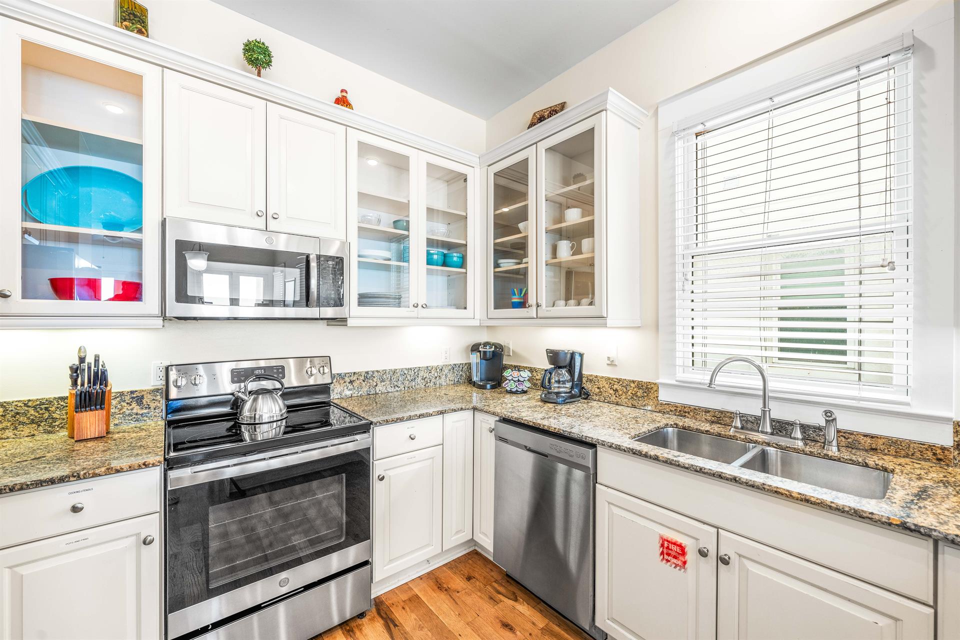 Stainless steel appliances with granite countertops in this wellstocked kitchen